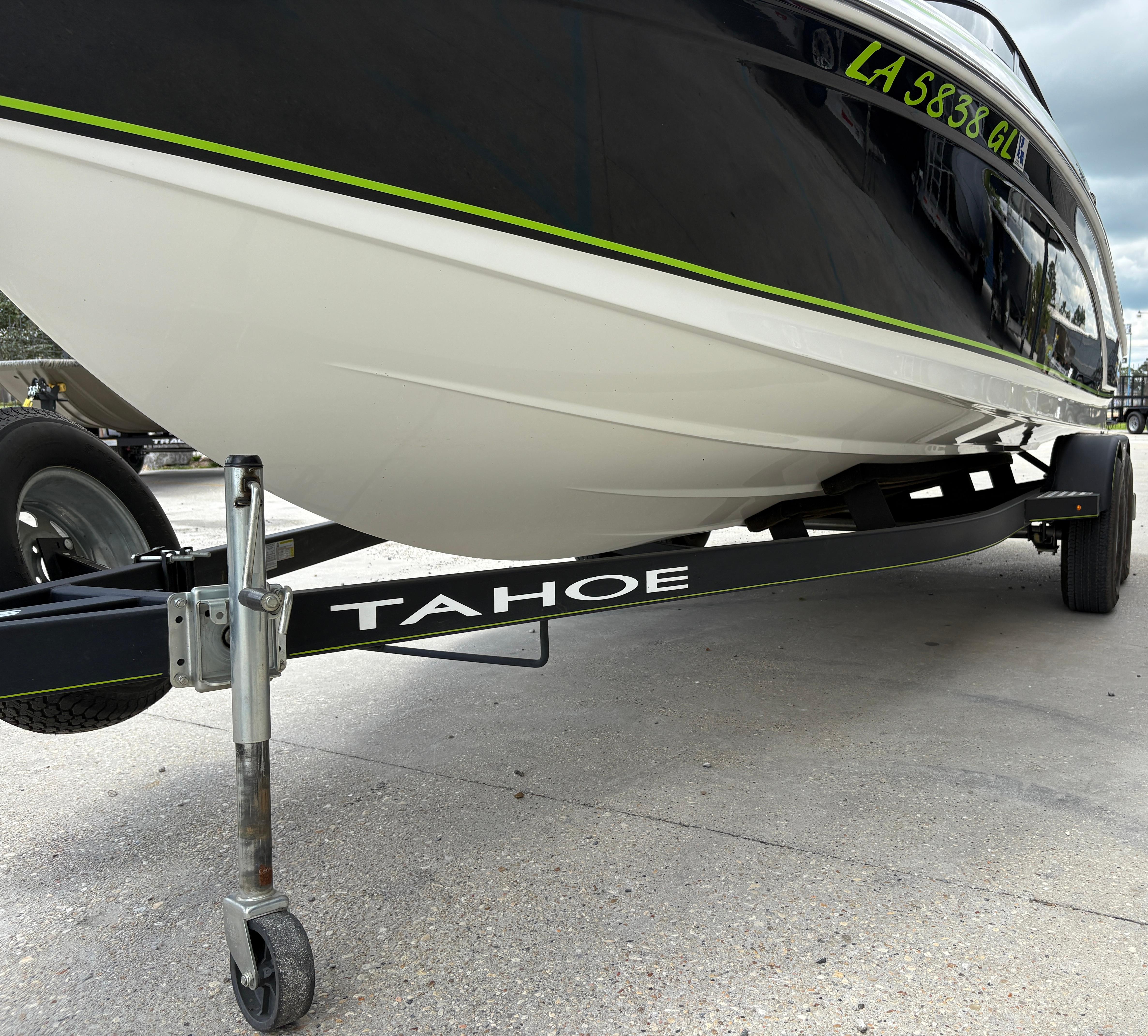 2019 Tahoe 700 boat on trailer, close-up view of hull and wheels.