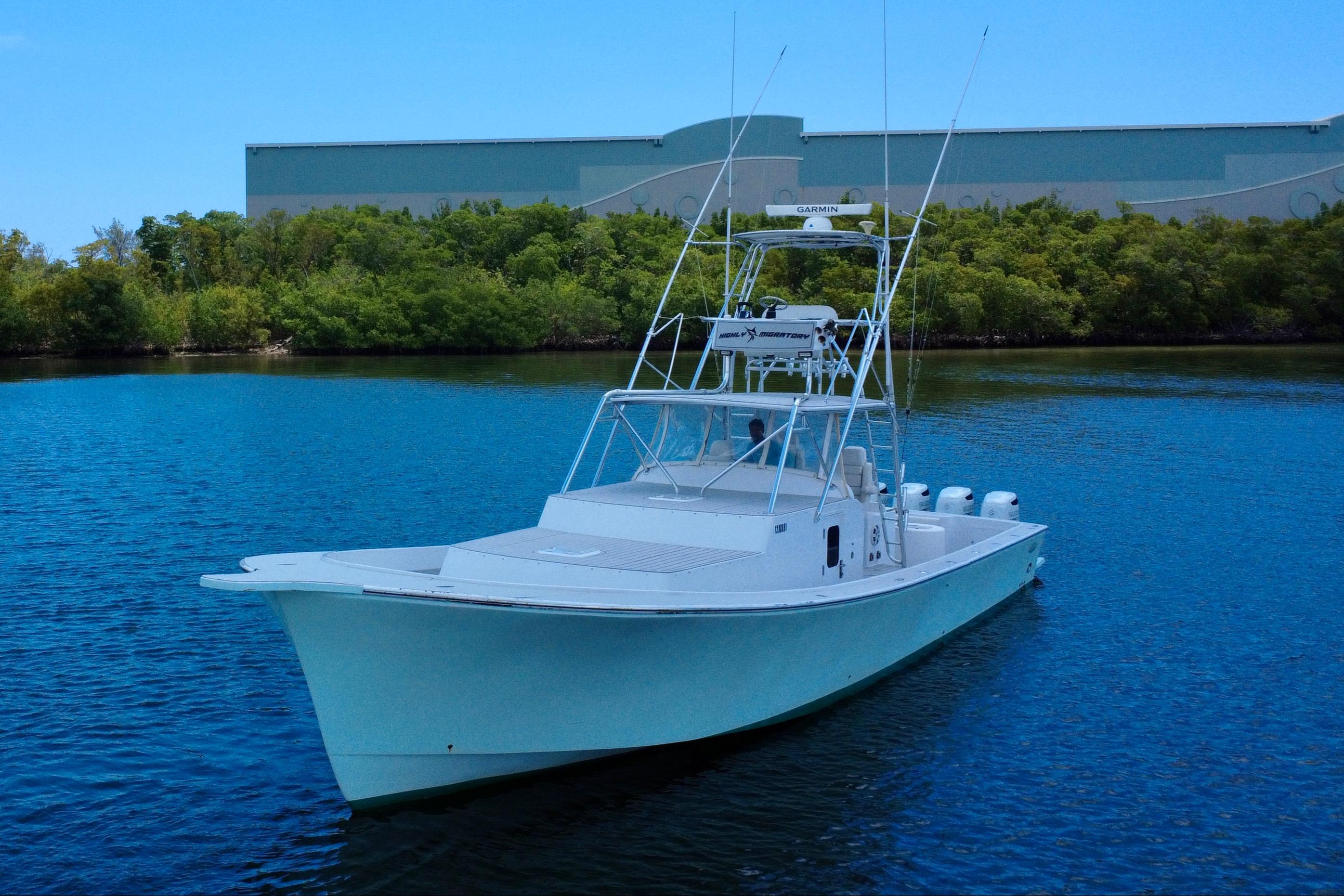 Chesapeake-53 Center Console 2017-Highly Migratory FL-US-2017 Chesapeake 53 Center Console boat on calm water near greenery.-9795522 | Thumbnail