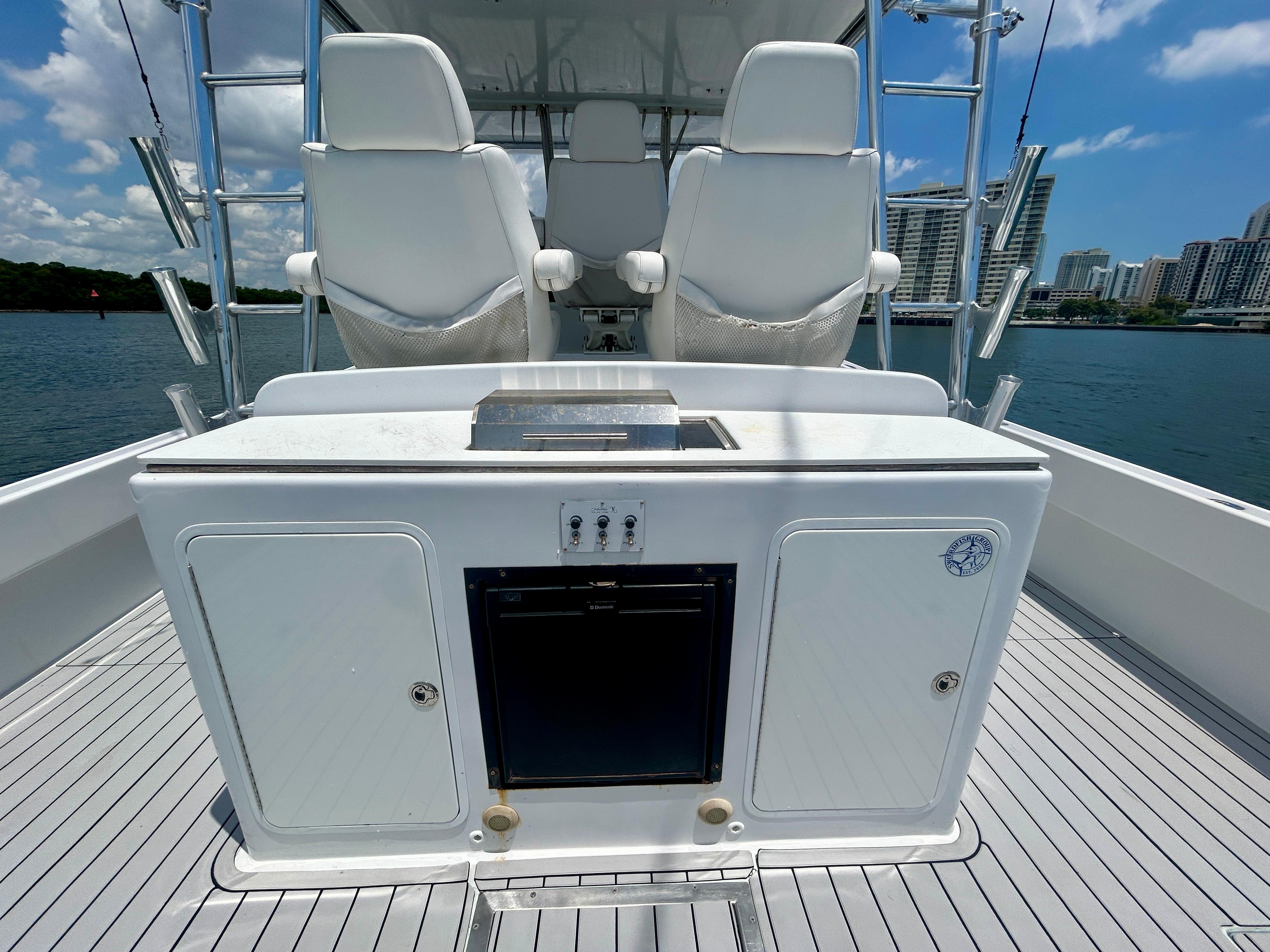 Chesapeake-53 Center Console 2017-Highly Migratory FL-US-2017 Chesapeake 53 Center Console boat interior with seating and storage, docked near cityscape.-9795522 | Thumbnail