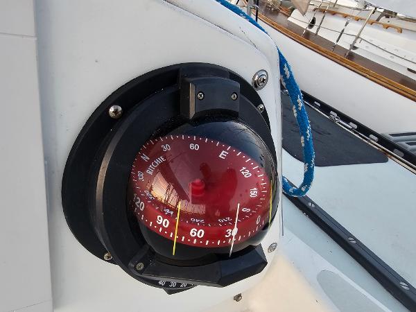 Compass on 1984 Schock NY 36 sailboat, featuring a red Ritchie compass.