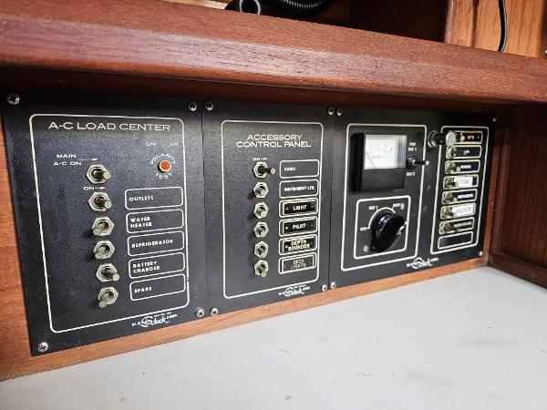 Control panel of a 1984 Schock NY 36 sailboat, featuring A-C load center and accessory controls.