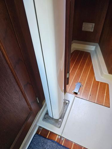 Interior view of 1984 Schock NY 36 sailboat, featuring wooden flooring and structural details.