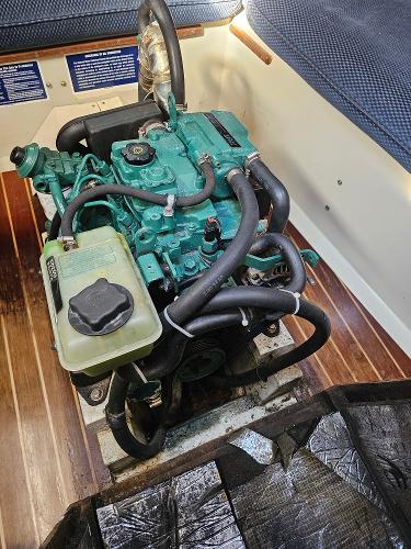 Engine of a 1984 Schock NY 36 sailboat, featuring a compact design and green components.