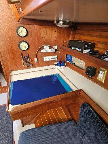 Interior of 1984 Schock NY 36 sailboat with navigation station and wooden cabinetry.