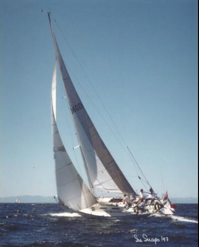 Sailing yacht Schock NY 36, 1984 model, gliding on open water under clear skies.
