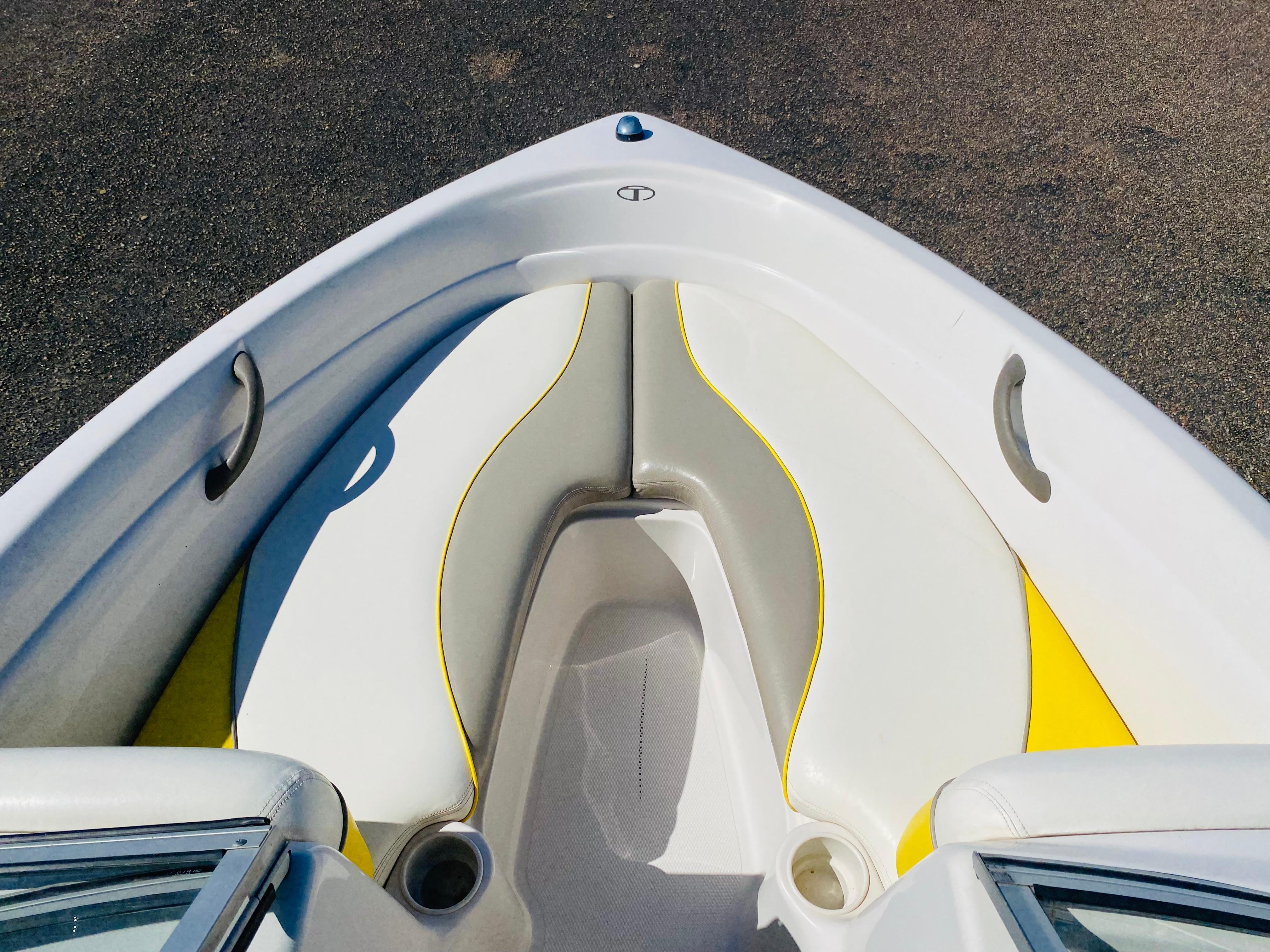 2006 Tahoe Q4 Sport boat interior with white and yellow seating.
