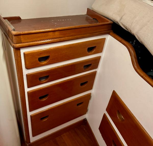 Wooden drawers inside a 1956 Aage Nielsen 50' Yawl, showcasing classic nautical craftsmanship.