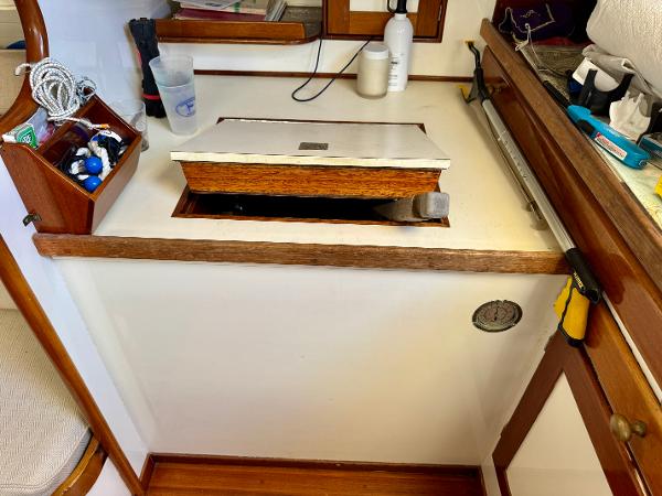 Interior of a 1956 Aage Nielsen 50' Yawl, featuring a wooden countertop and storage area.