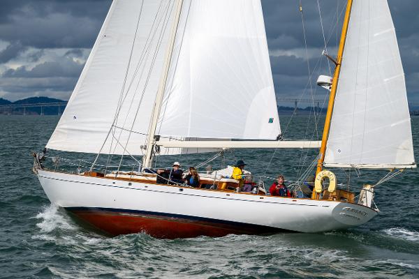 Aage Nielsen 50' Ketch sailing on open water, 1956 model, with crew onboard.