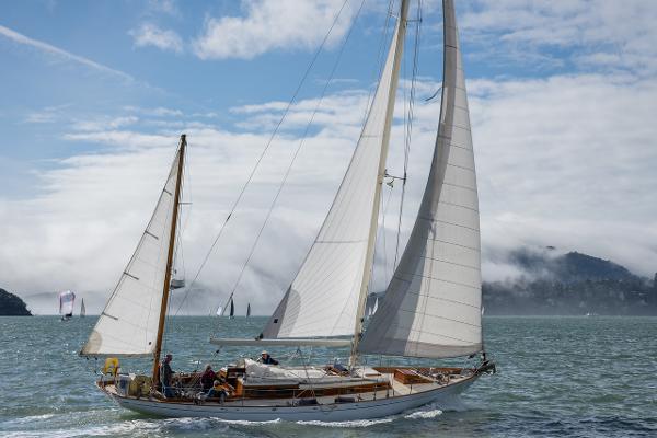 Vintage 1956 Aage Nielsen 50' Ketch sailing on a misty sea.