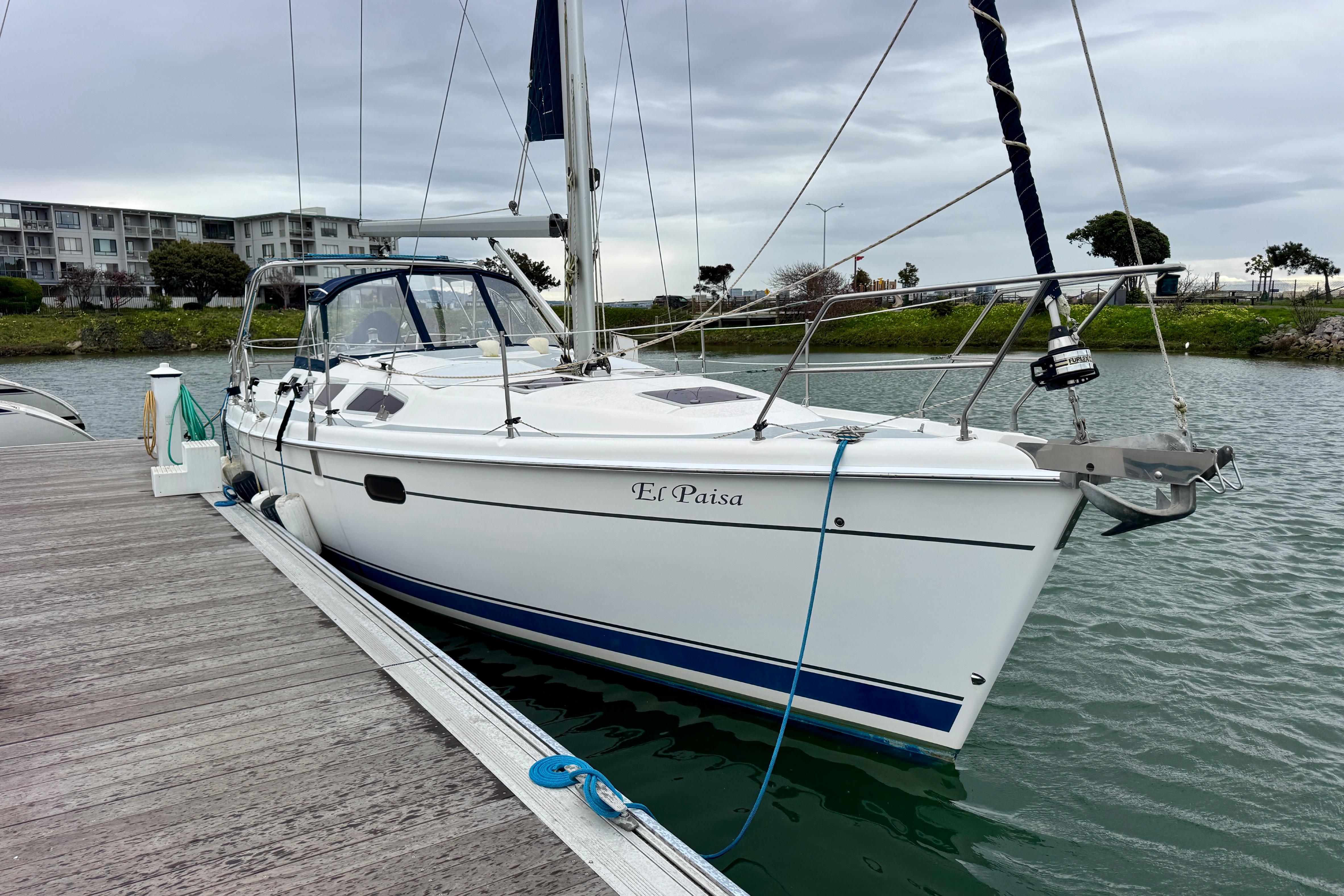 2004 Hunter 386 sailboat docked at marina, overcast sky, named "El Paisa".