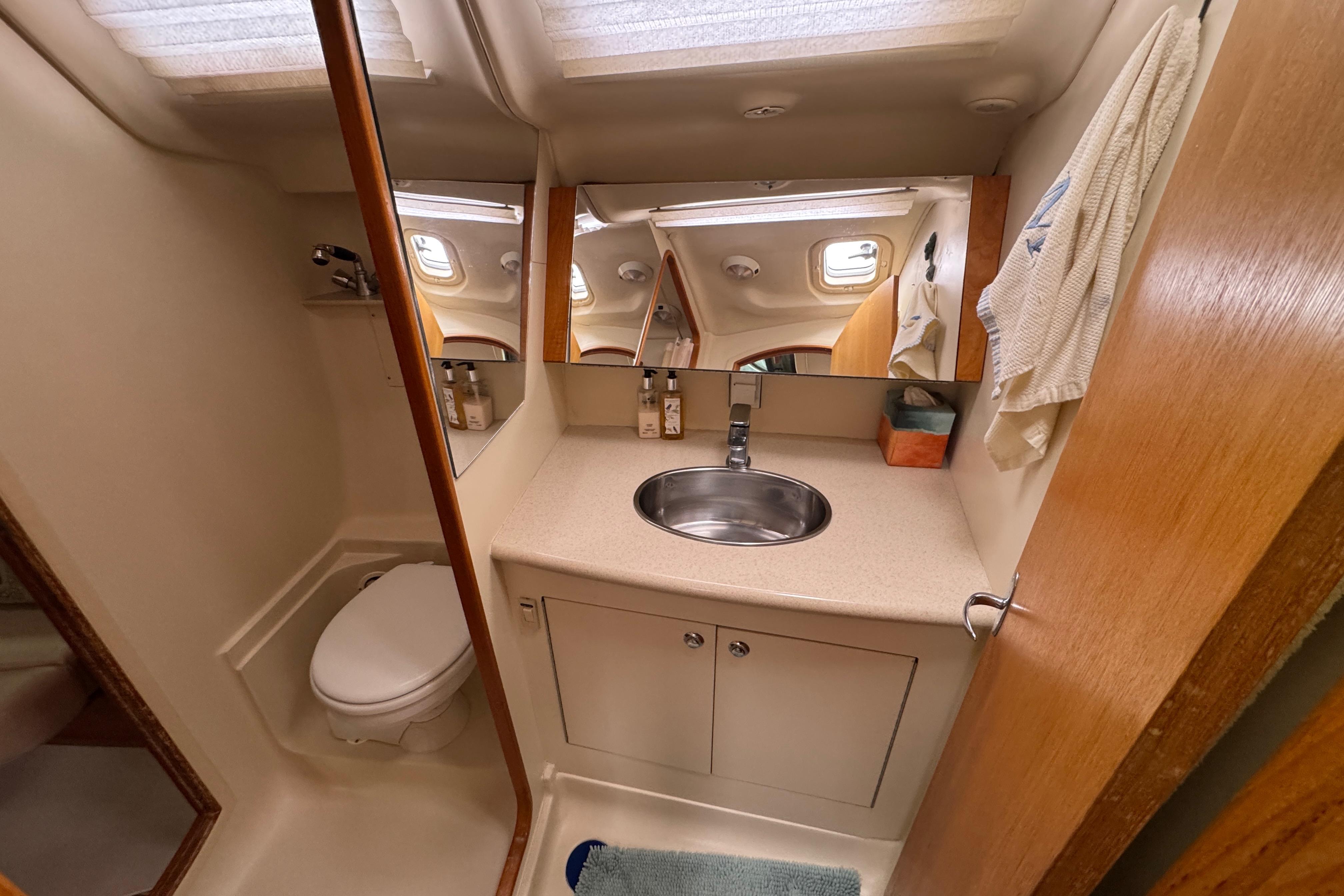2004 Hunter 386 yacht bathroom with sink, mirror, and toilet.