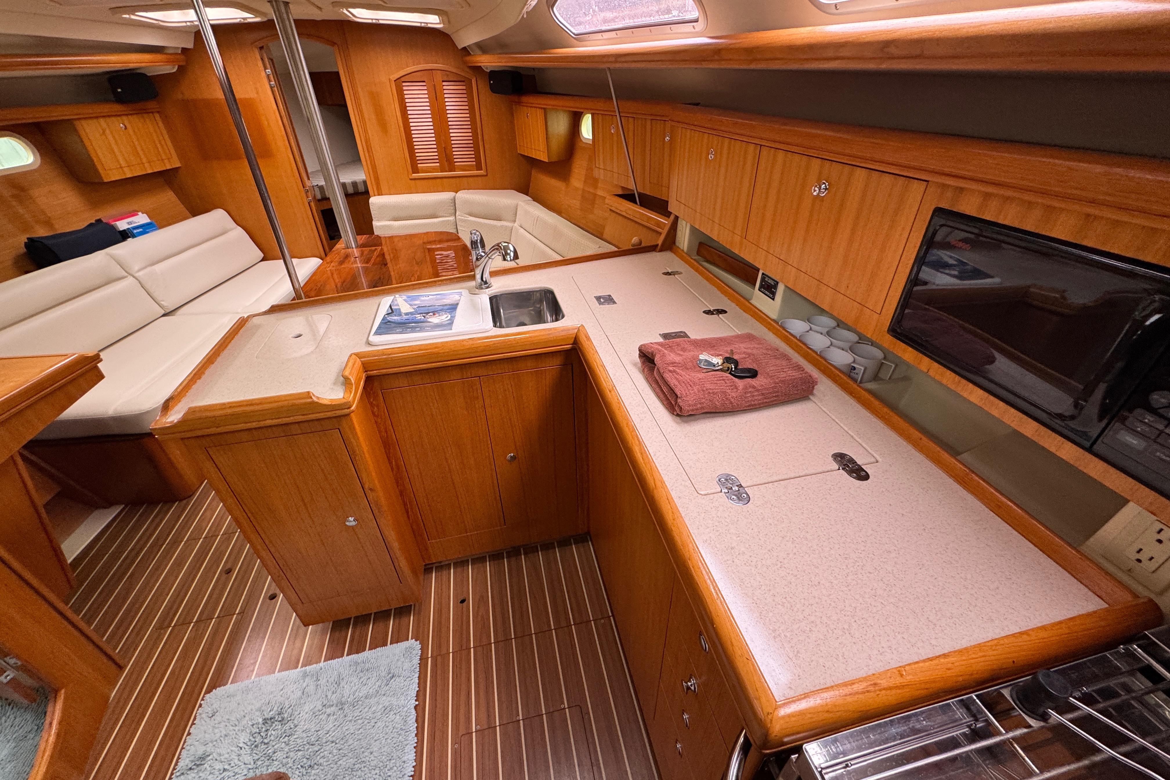 Interior of 2004 Hunter 386 sailboat with wood cabinetry and modern amenities.