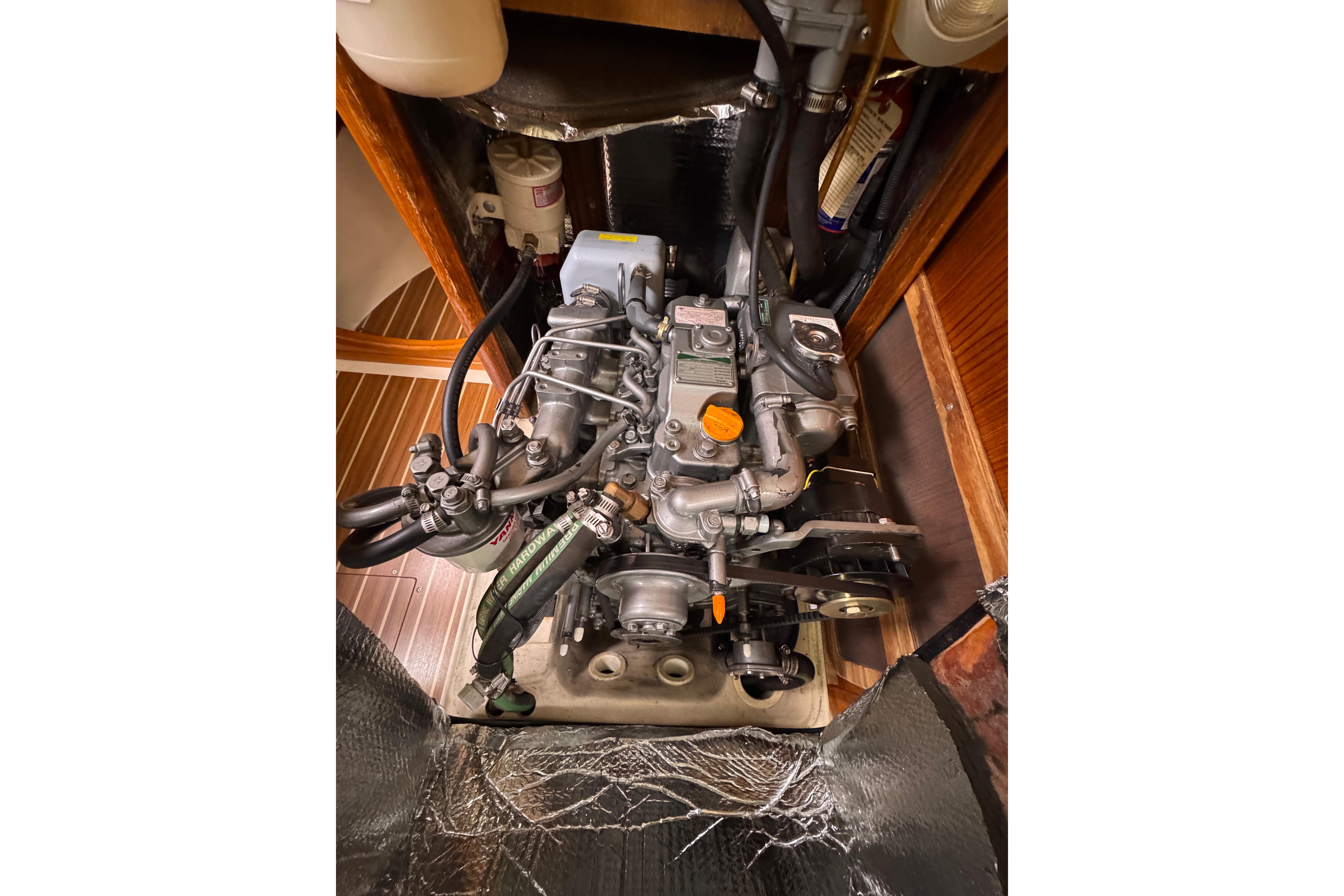 Engine compartment of a 2004 Hunter 386 sailboat, showcasing detailed mechanical components.