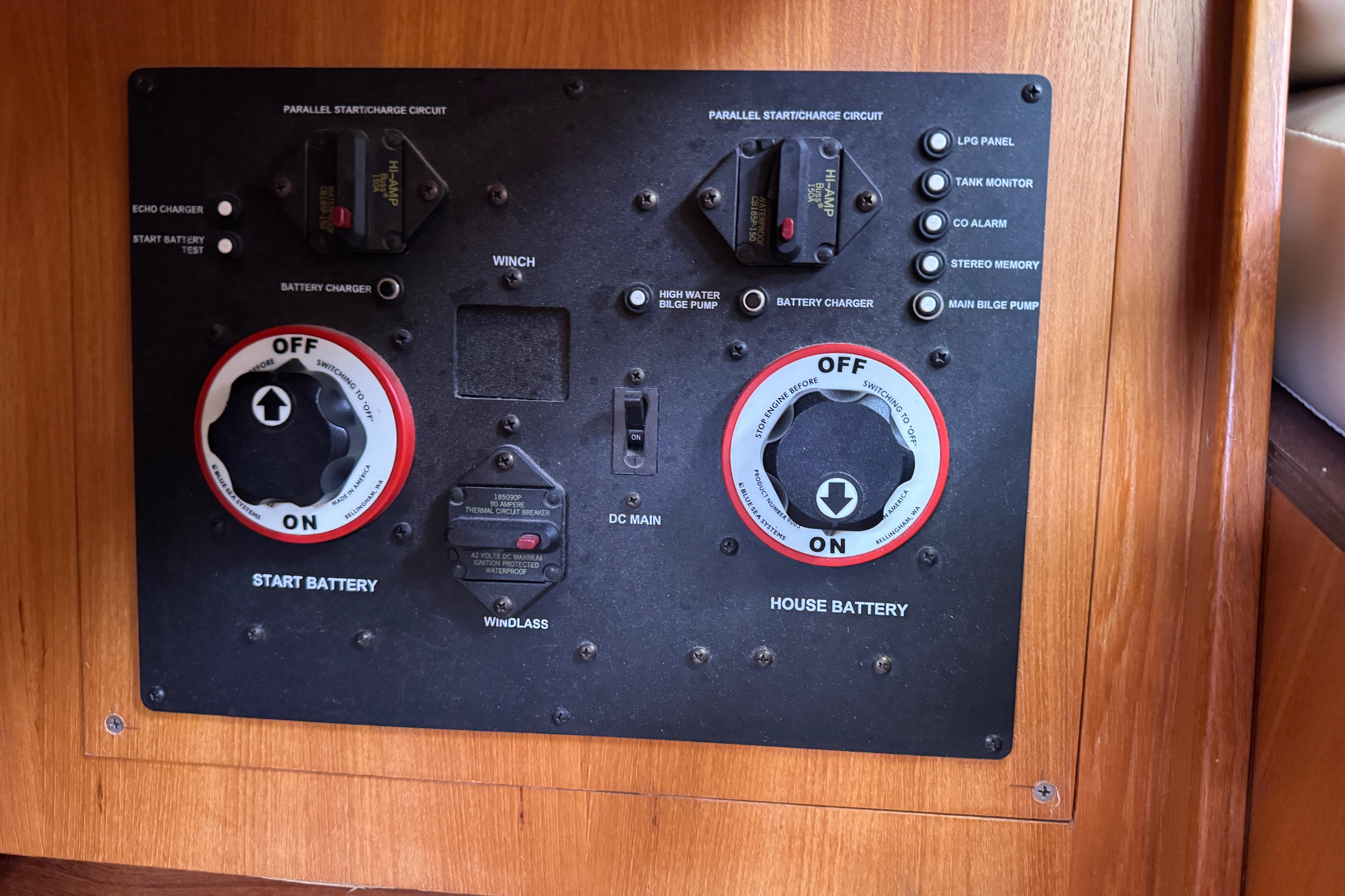 Control panel of a 2004 Hunter 386 sailboat with battery switches and circuit breakers.