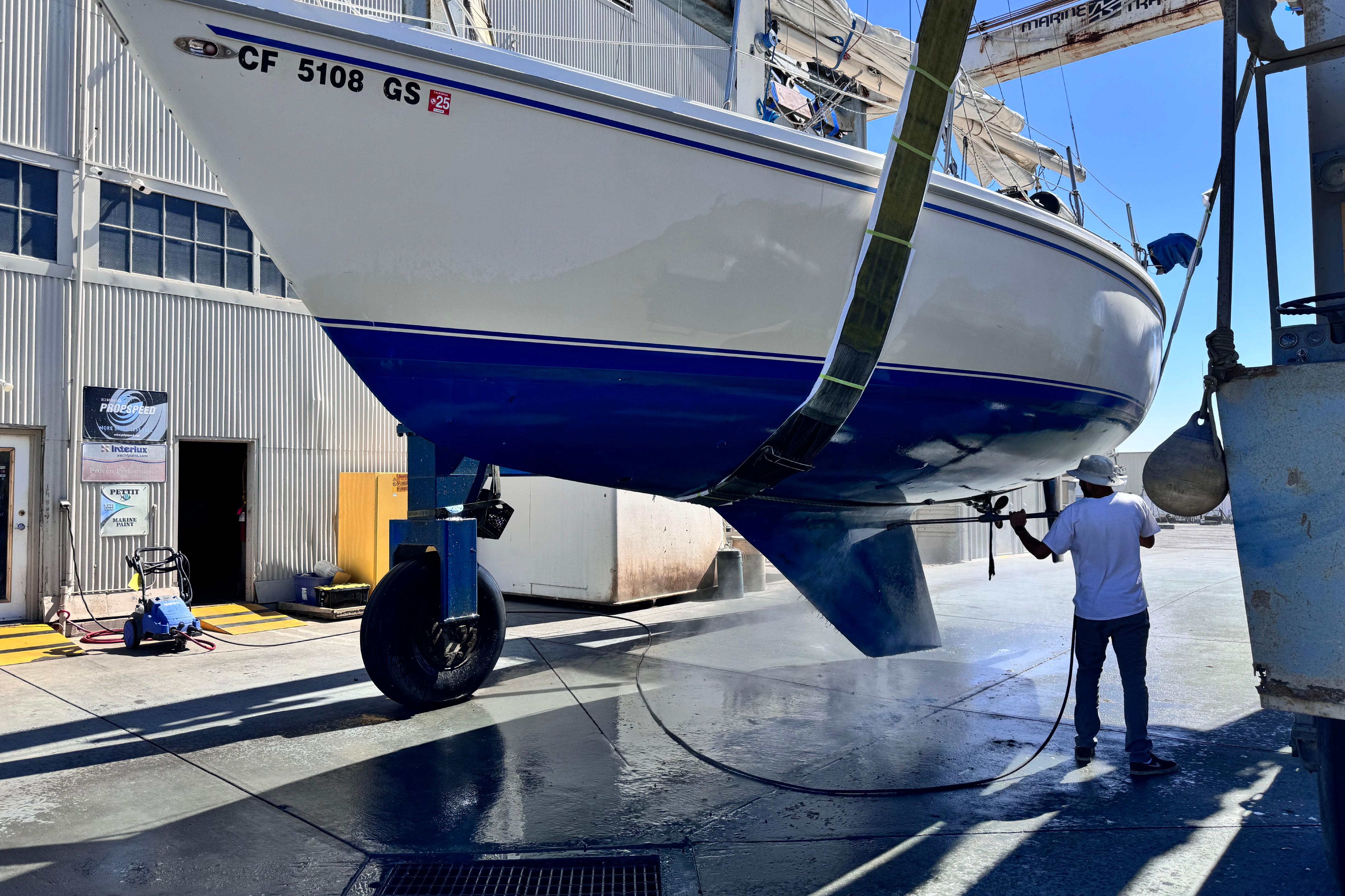 1980 Catalina 30 sailboat undergoing maintenance at a marina facility.