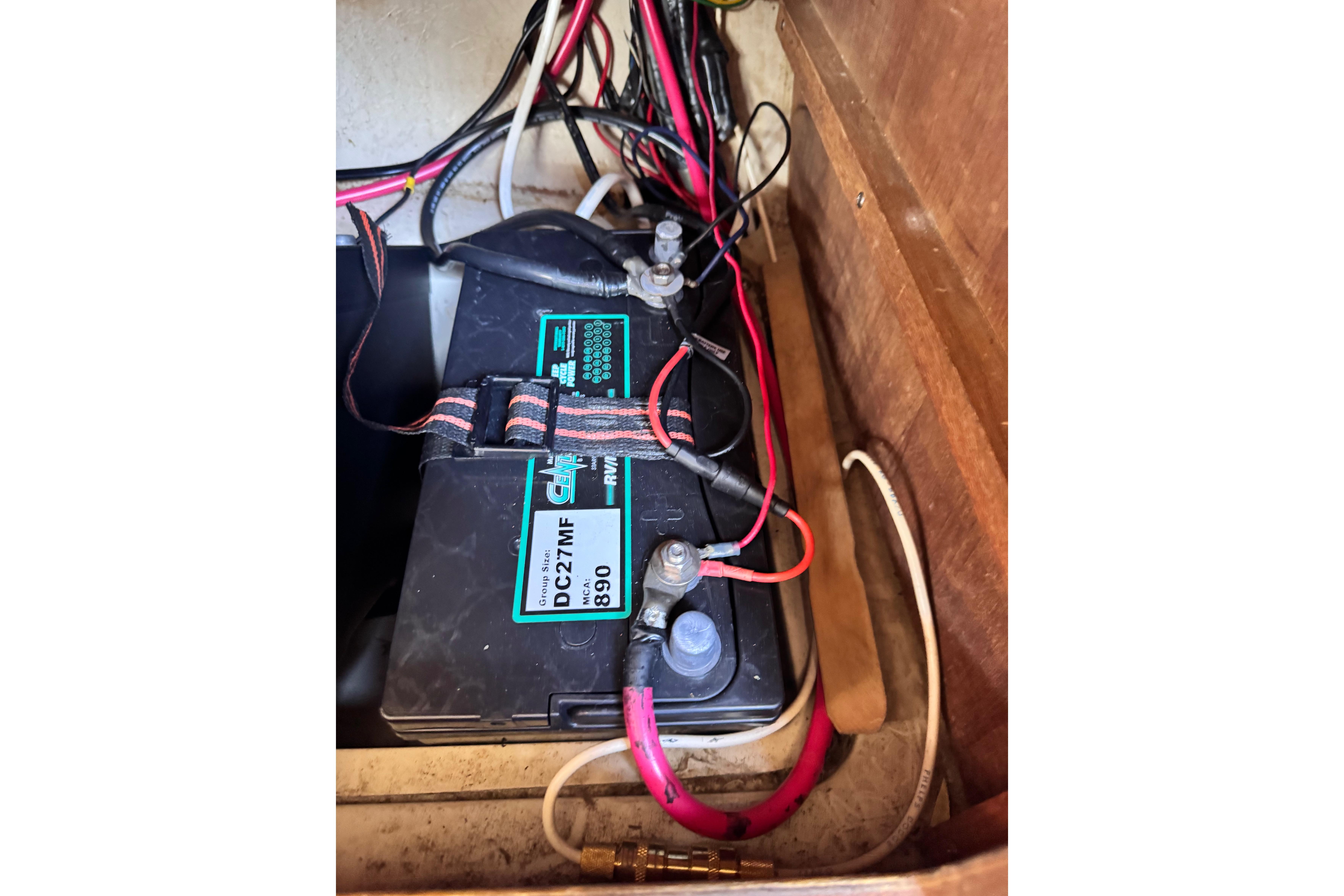 Battery compartment of a 1980 Catalina 30 sailboat with wiring connections.