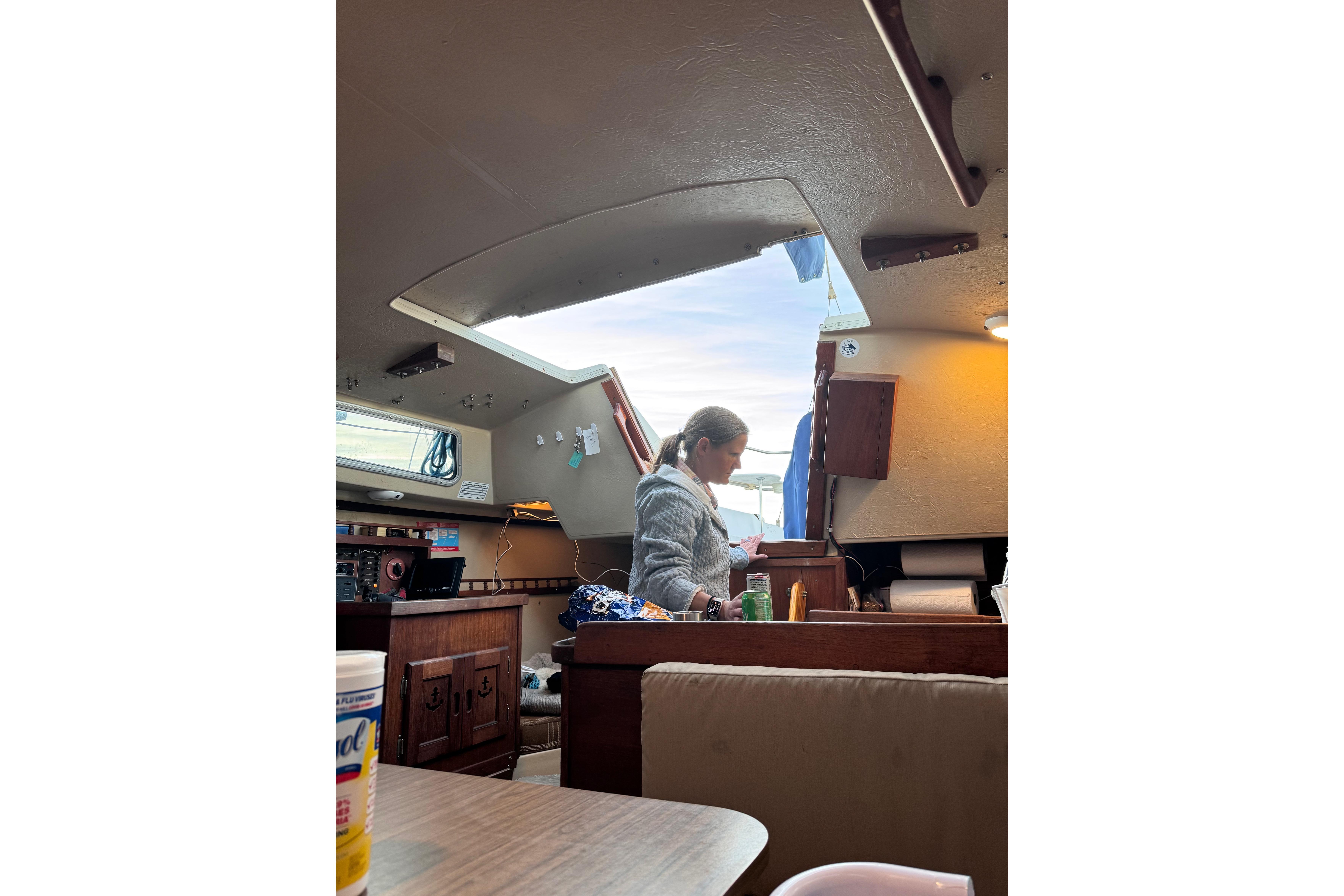 Interior of a 1980 Catalina 30 sailboat with a person in the cabin.
