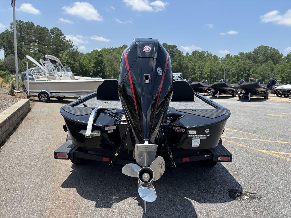 2025 Tracker SAVAGE™ 215 boat, rear view, parked outdoors on a sunny day.