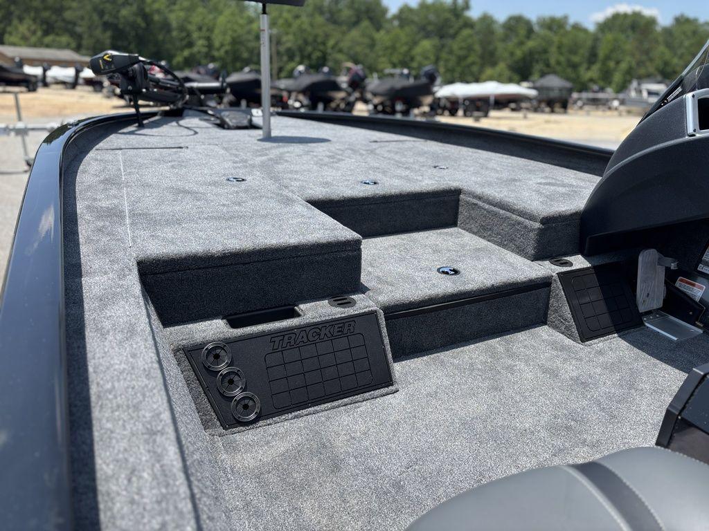 2025 Tracker SAVAGE™ 215 boat deck with carpeted surface and storage compartments.