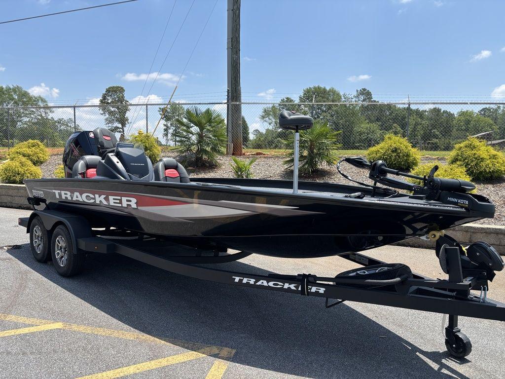 2025 Tracker SAVAGE™ 215 boat on trailer, parked outdoors under clear sky.