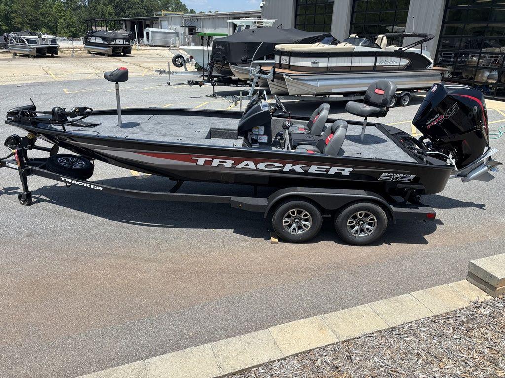 2025 Tracker SAVAGE™ 215 boat on trailer, parked outdoors, side view.
