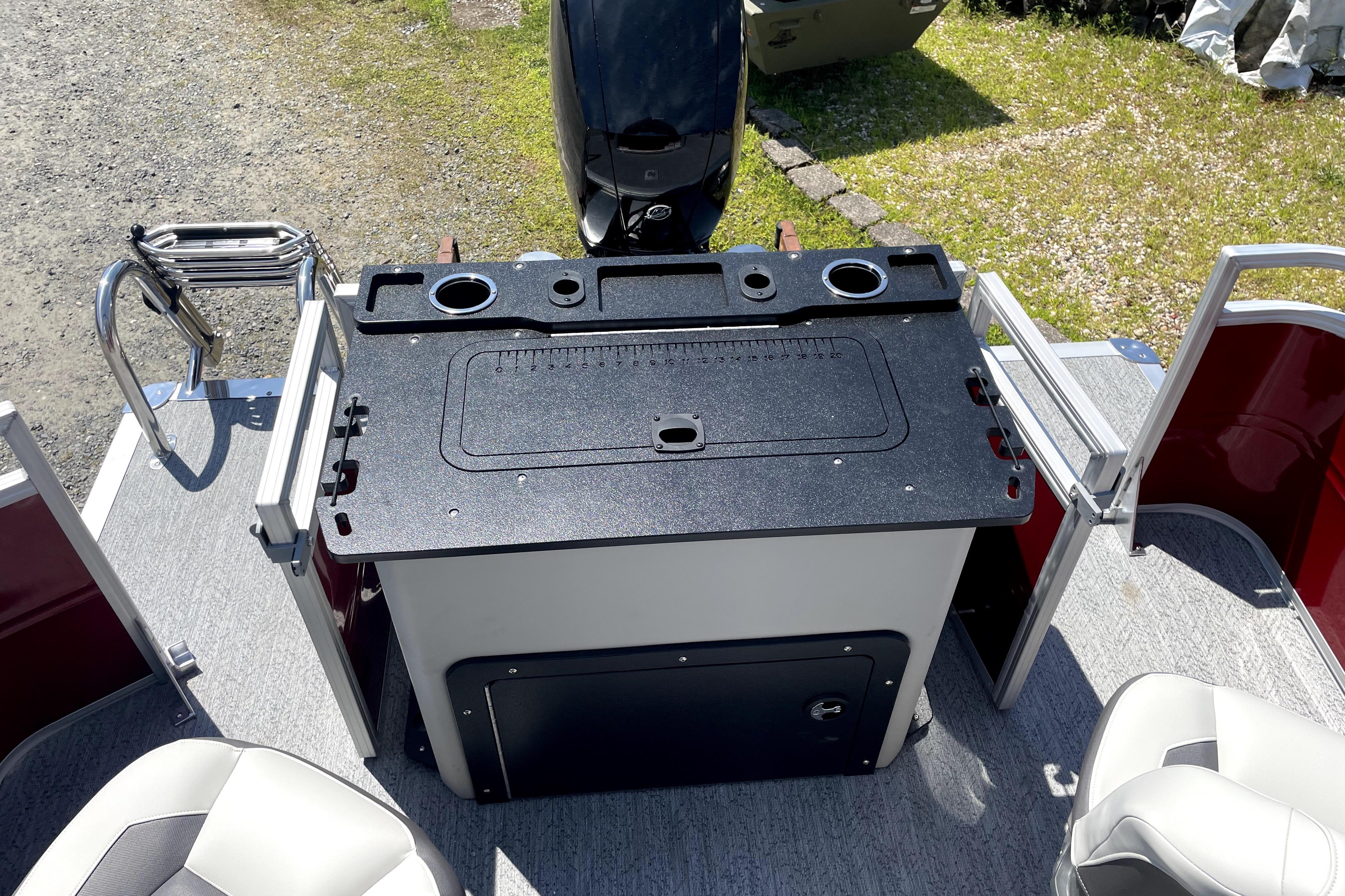 2026 Sun Tracker Fishin' Barge 22 DLX boat interior with fishing station and seating.