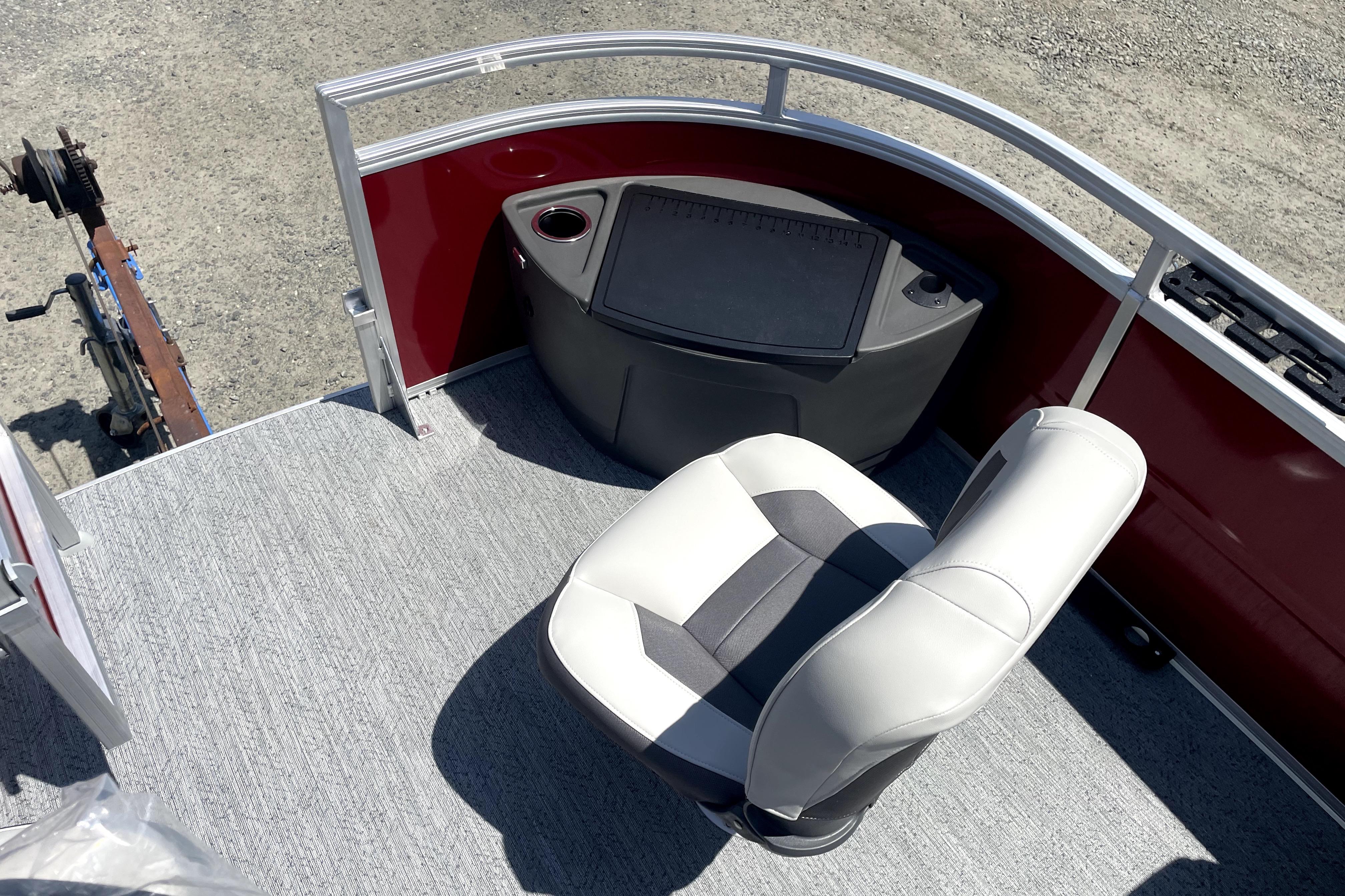 2026 Sun Tracker Fishin' Barge 22 DLX interior with seating and control panel.