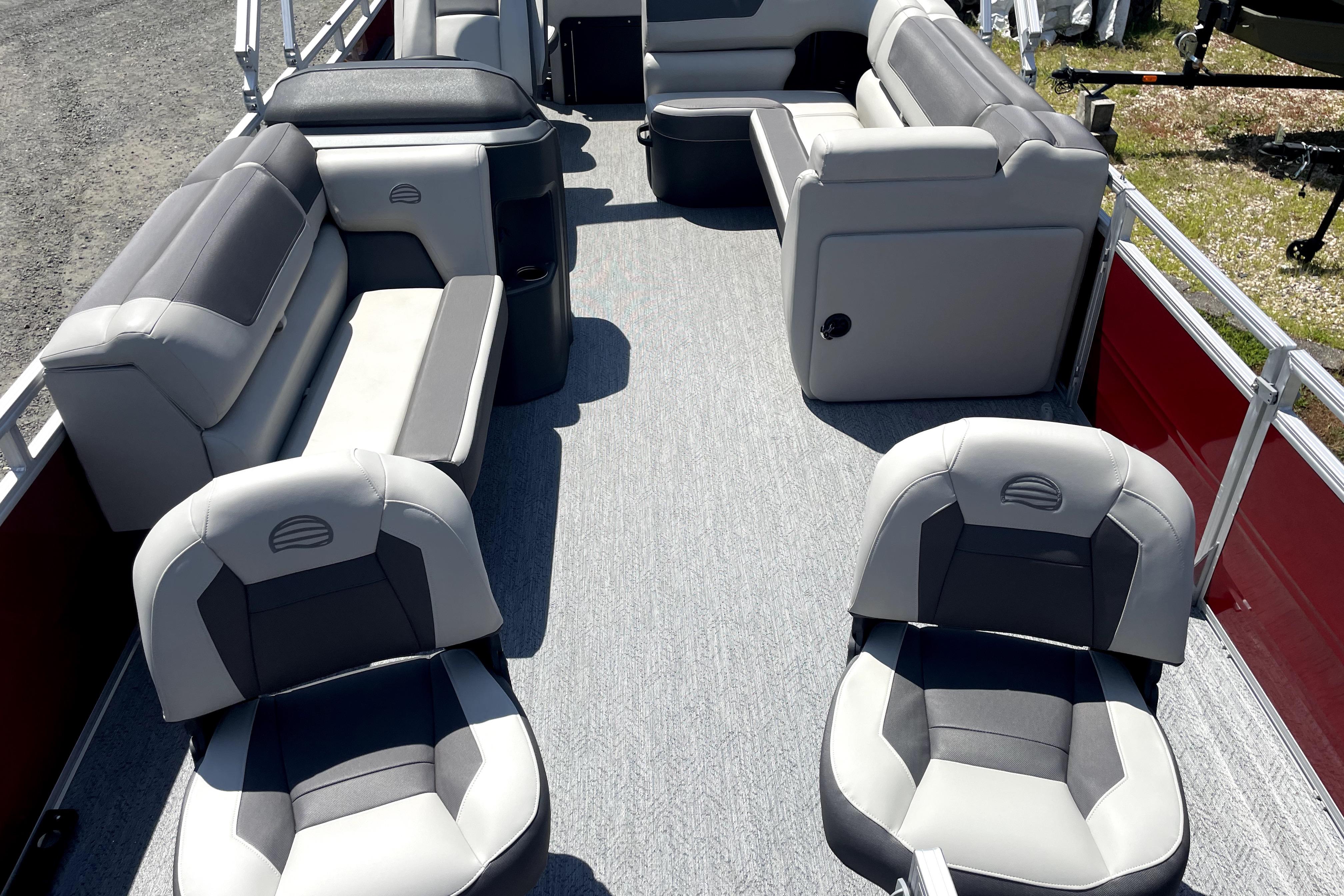 2026 Sun Tracker Fishin' Barge 22 DLX interior with gray seating and spacious layout.