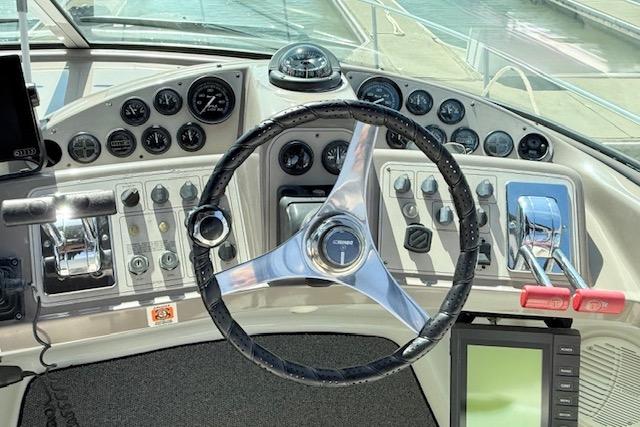 1997 Carver 350 Mariner helm with steering wheel, gauges, and controls.
