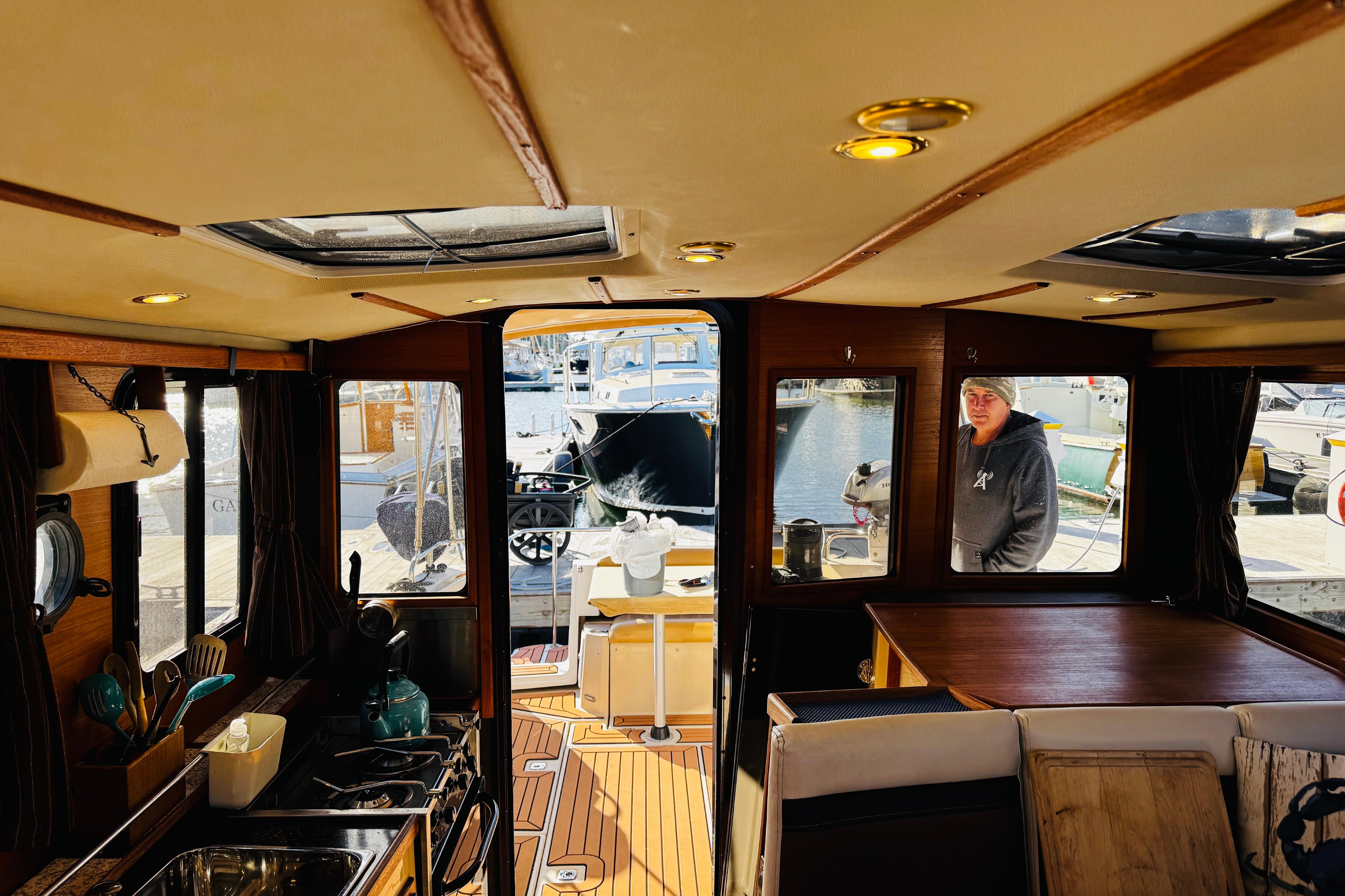 Interior of 2012 Ranger Tugs R-31 boat with kitchen and dining area.