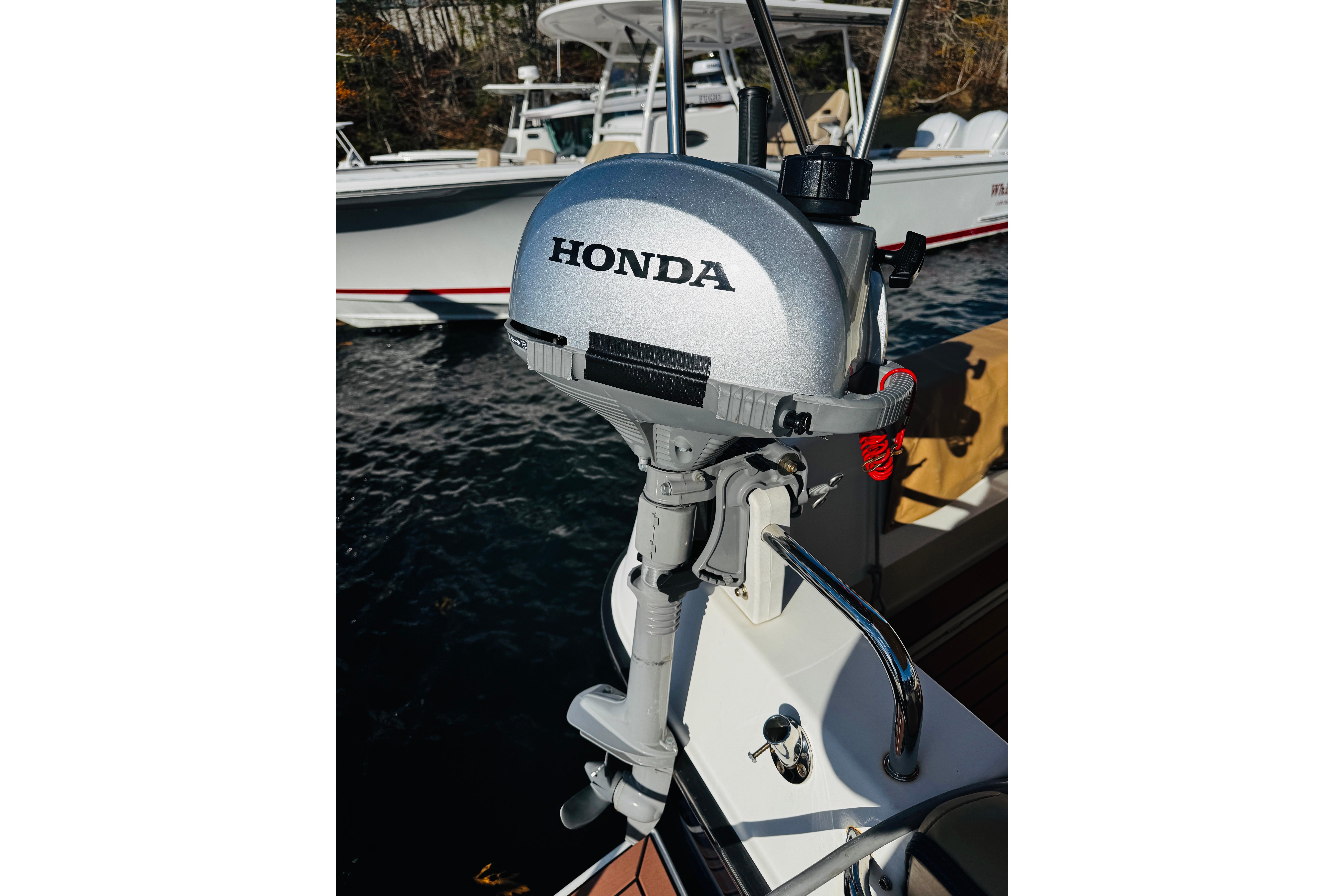 Honda outboard motor on 2012 Ranger Tugs R-31 boat, docked on water.