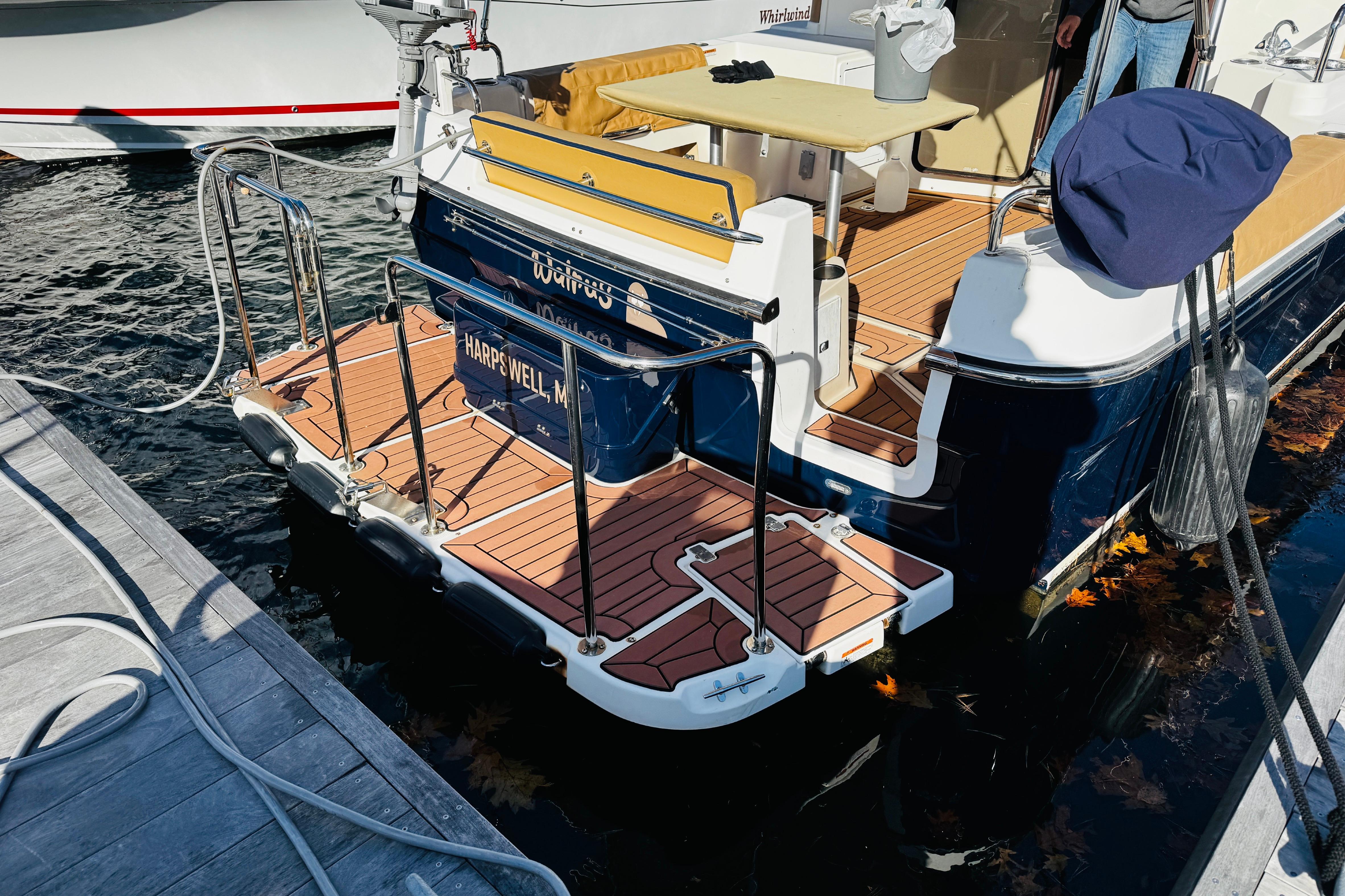 2012 Ranger Tugs R-31 boat docked, featuring teak deck and stainless steel railings.