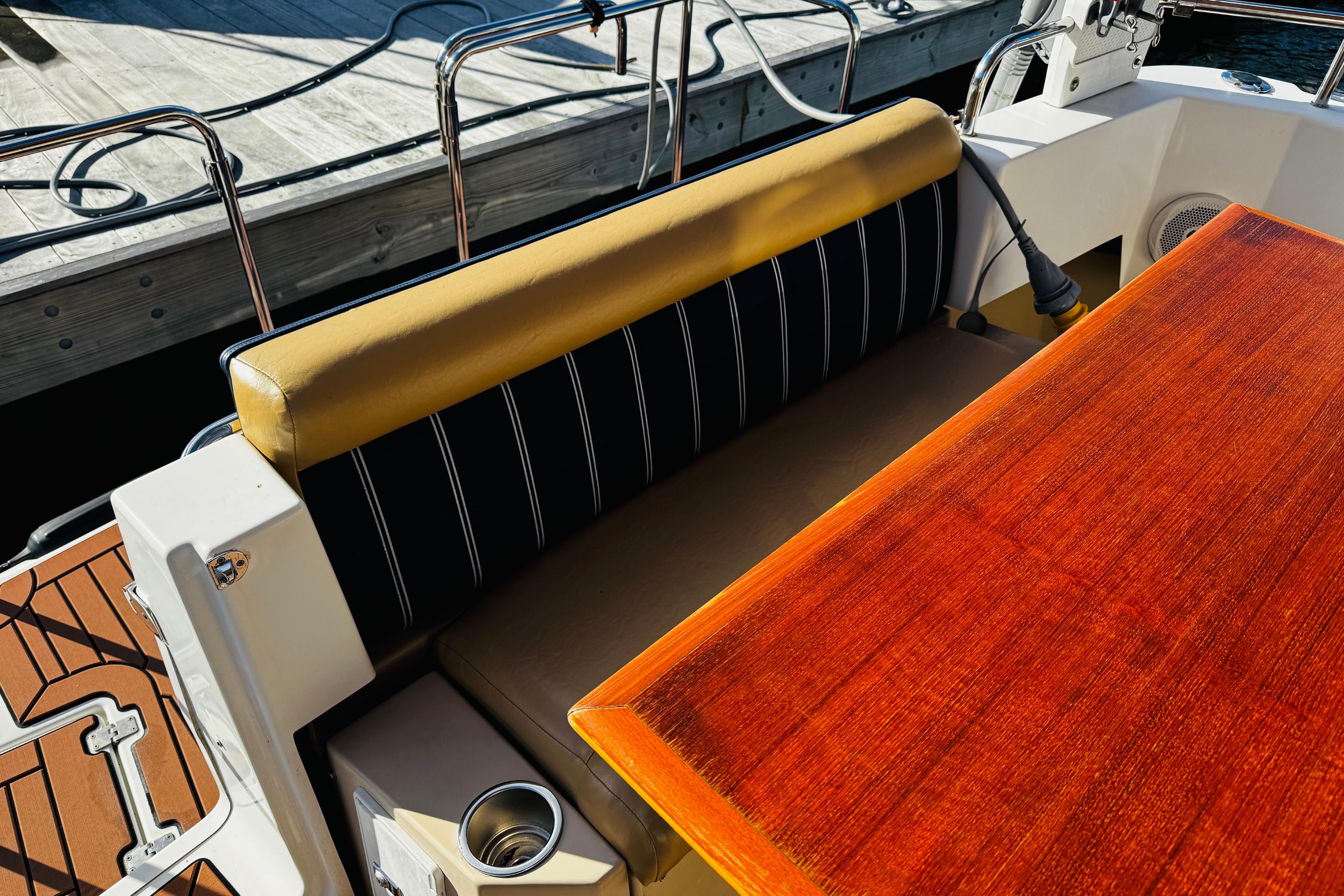 2012 Ranger Tugs R-31 boat interior with wooden table and cushioned seating.