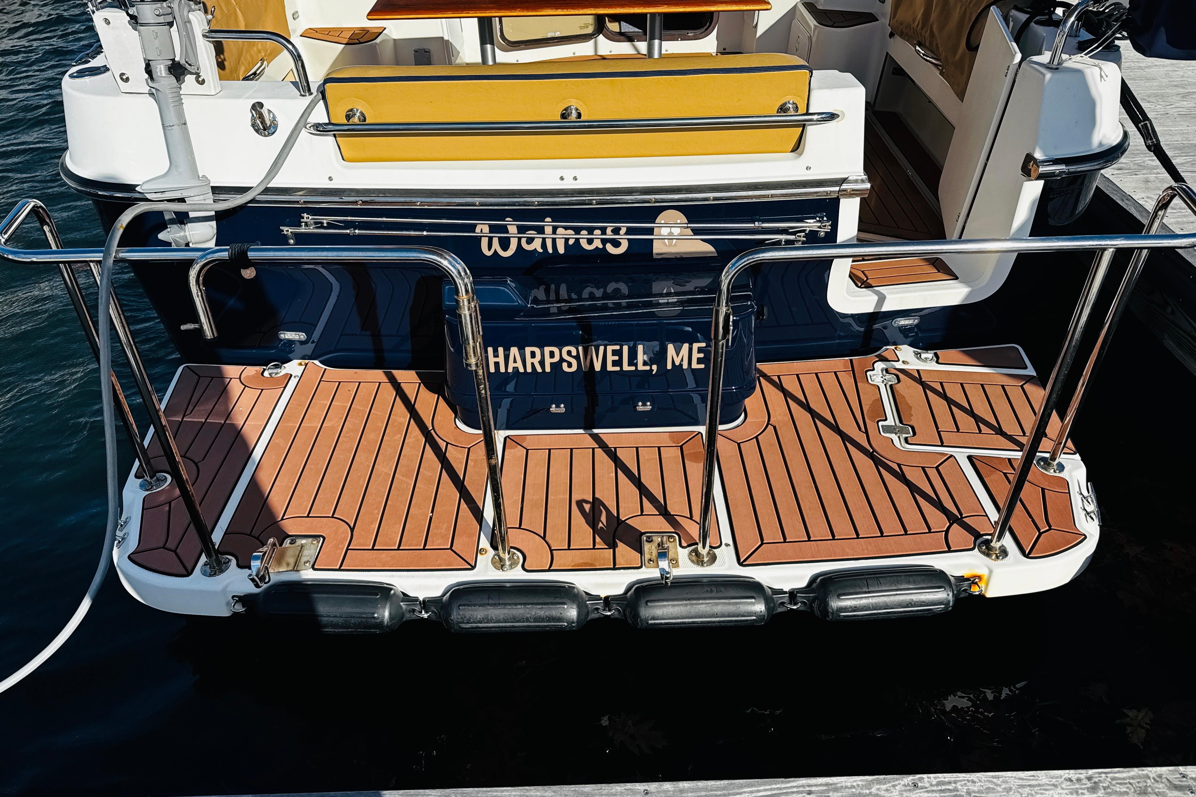 2012 Ranger Tugs R-31 boat stern with wooden deck, docked in Harpswell, ME.