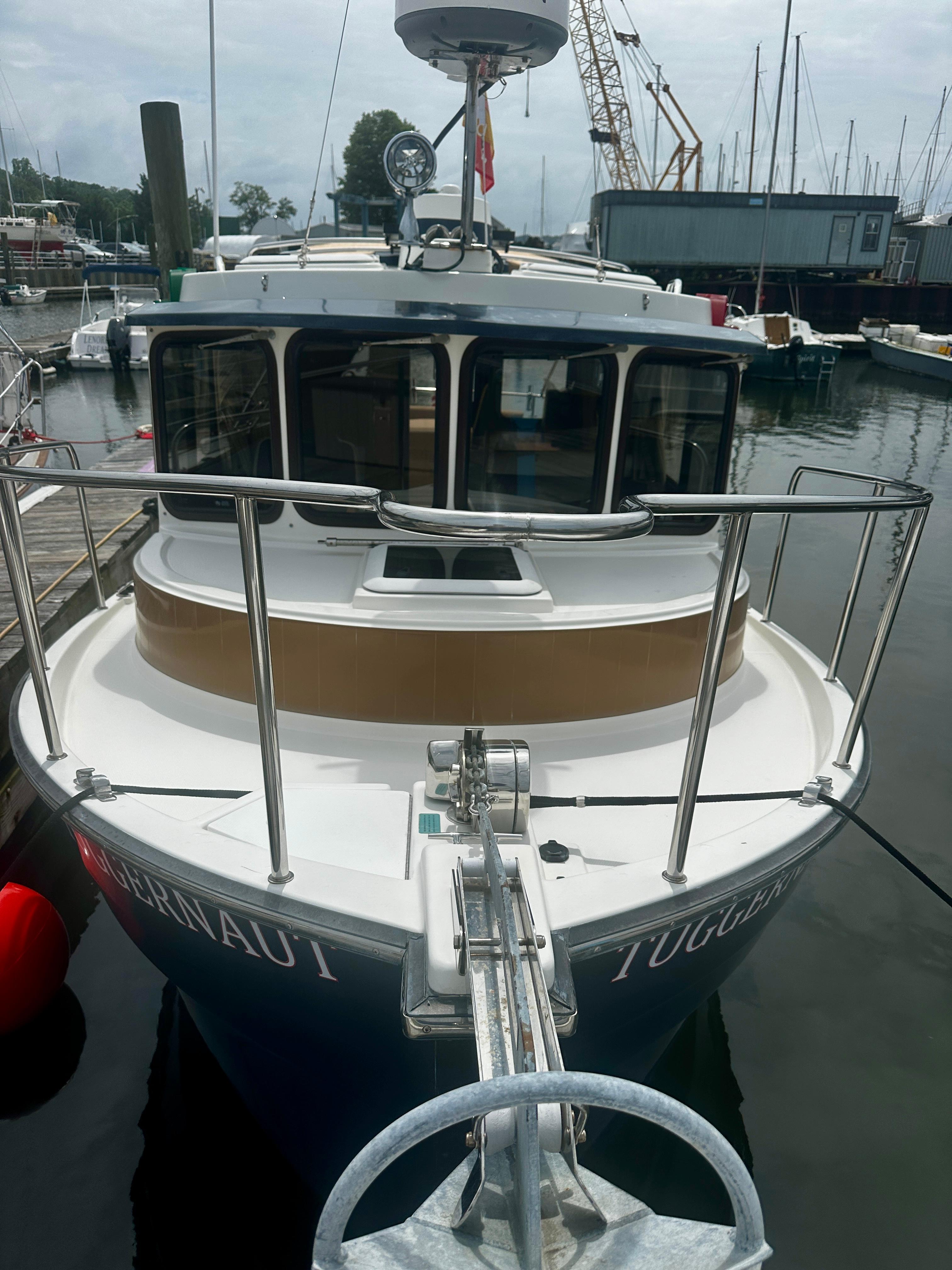 2014 American Tug R-27 docked at marina, front view.