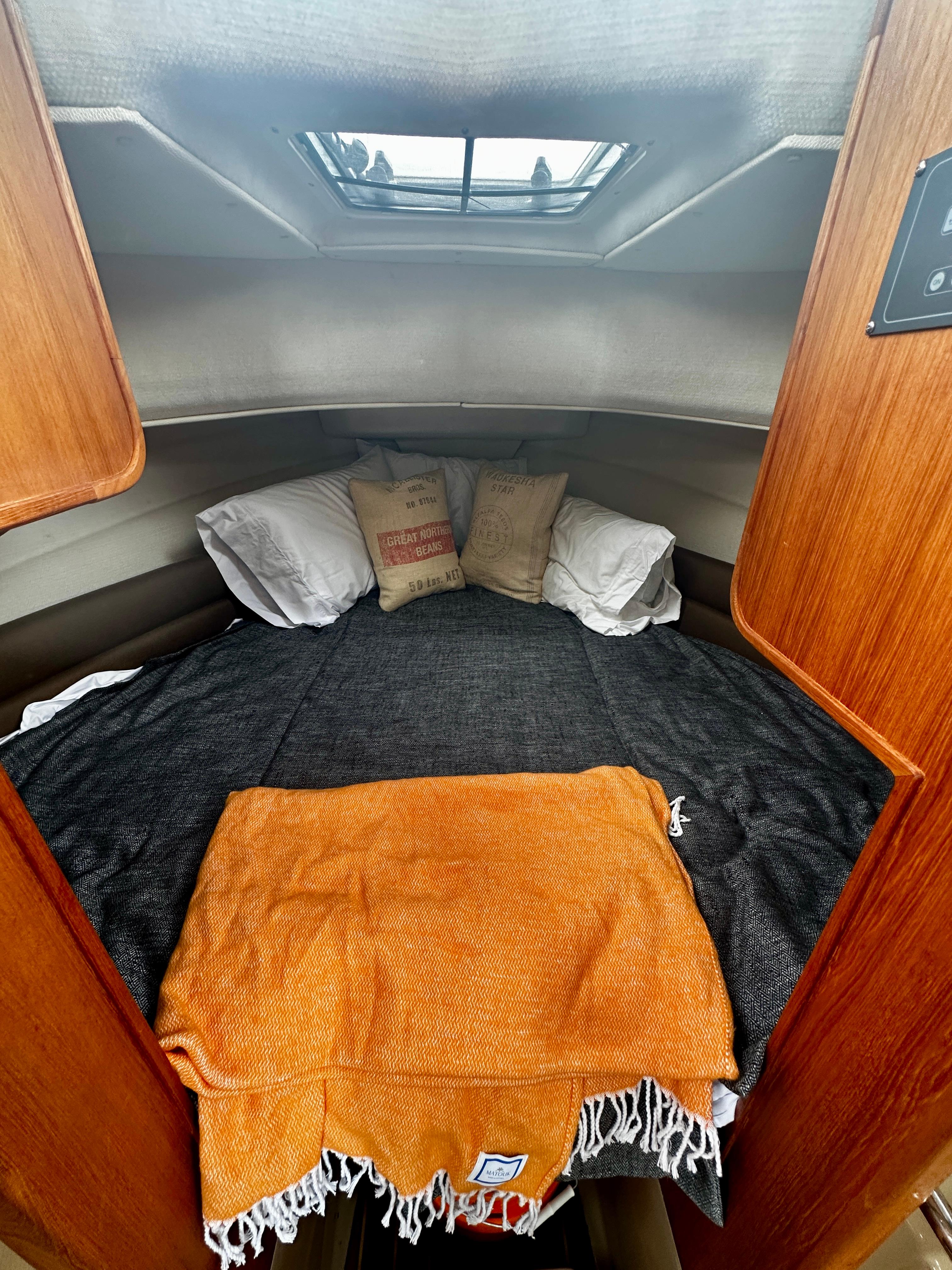 Cozy cabin interior of 2014 American Tug R-27 with bed and skylight.