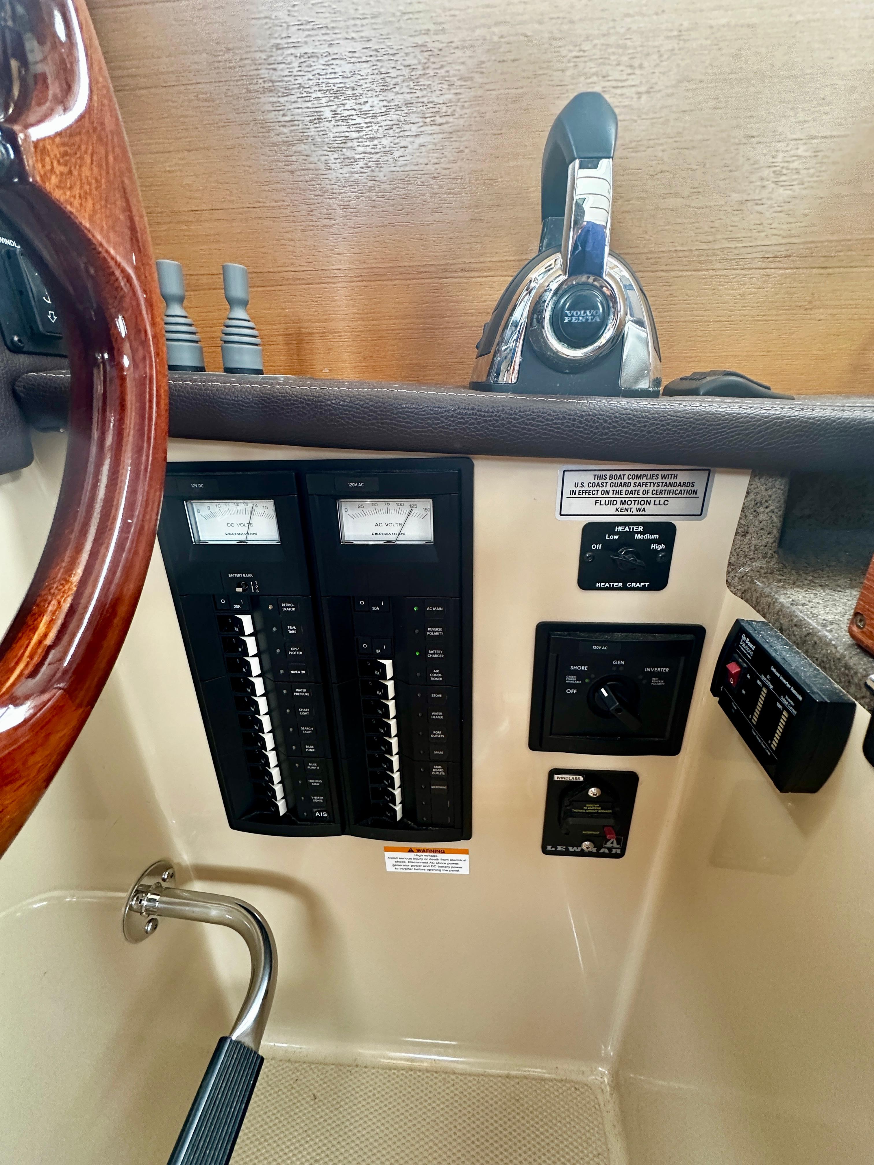 Control panel of a 2014 American Tug R-27 boat, featuring gauges and switches.