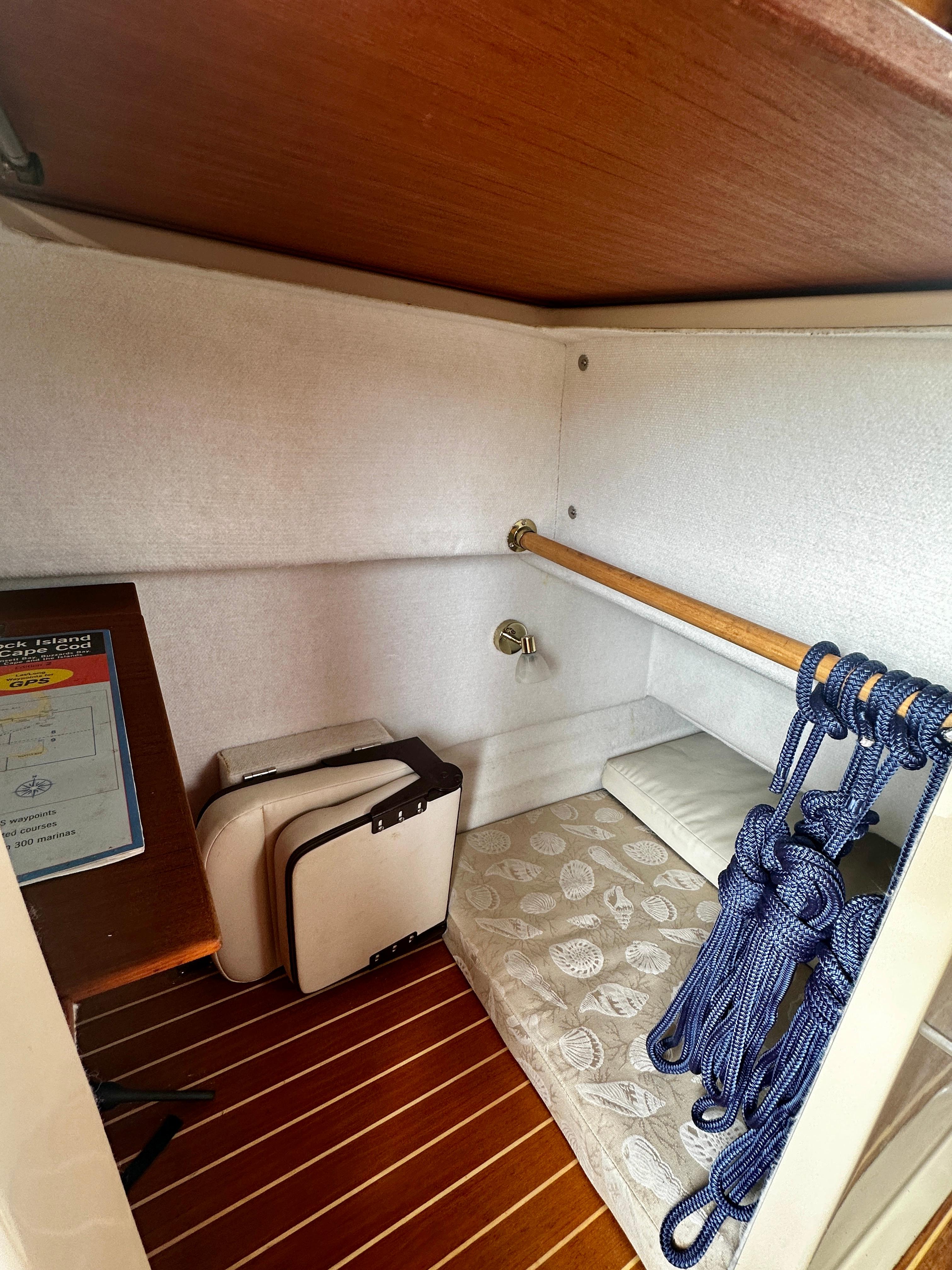 2014 American Tug R-27 cabin interior with wooden flooring and nautical ropes.