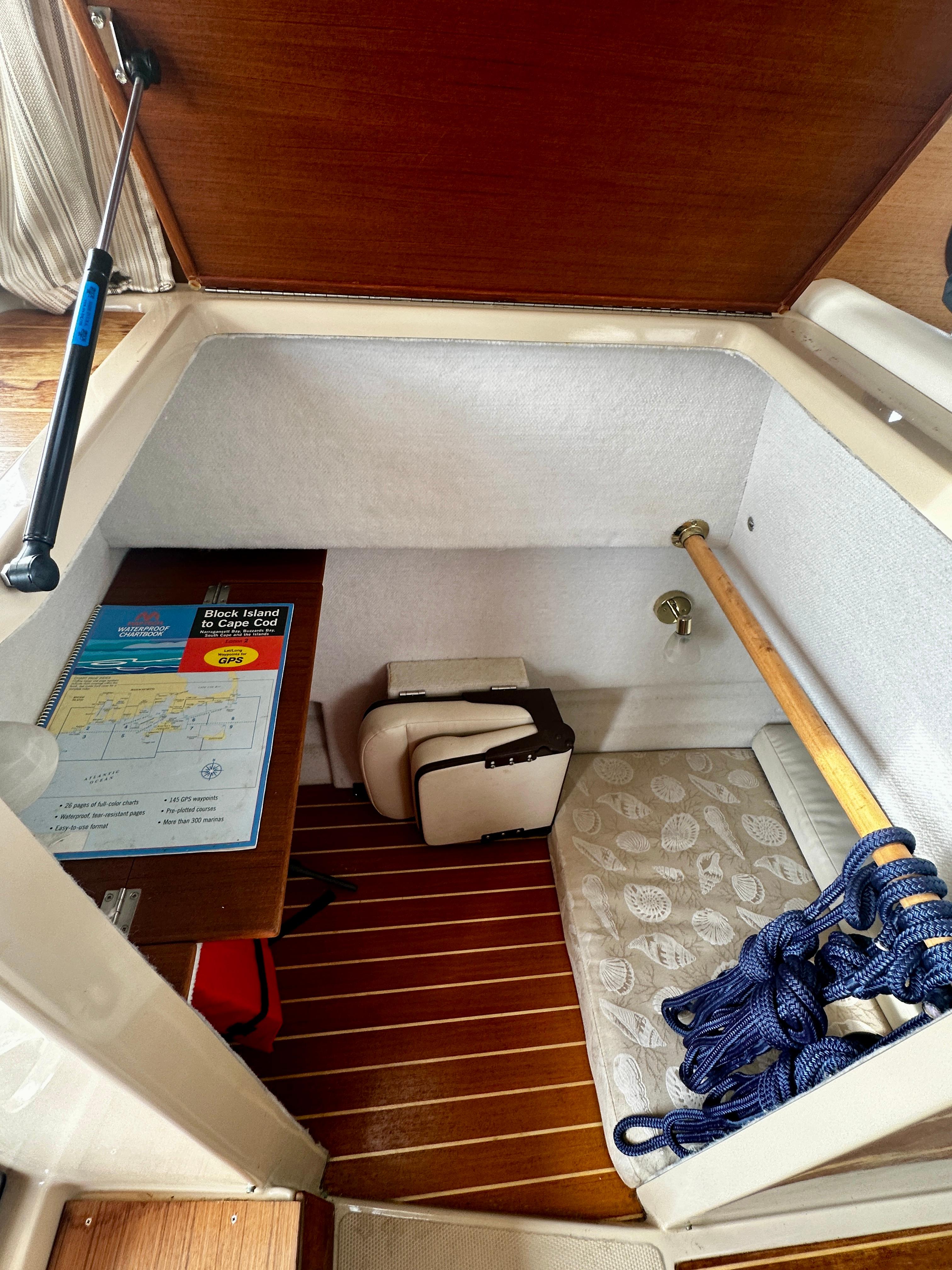 2014 American Tug R-27 storage compartment with map, cushions, and rope.