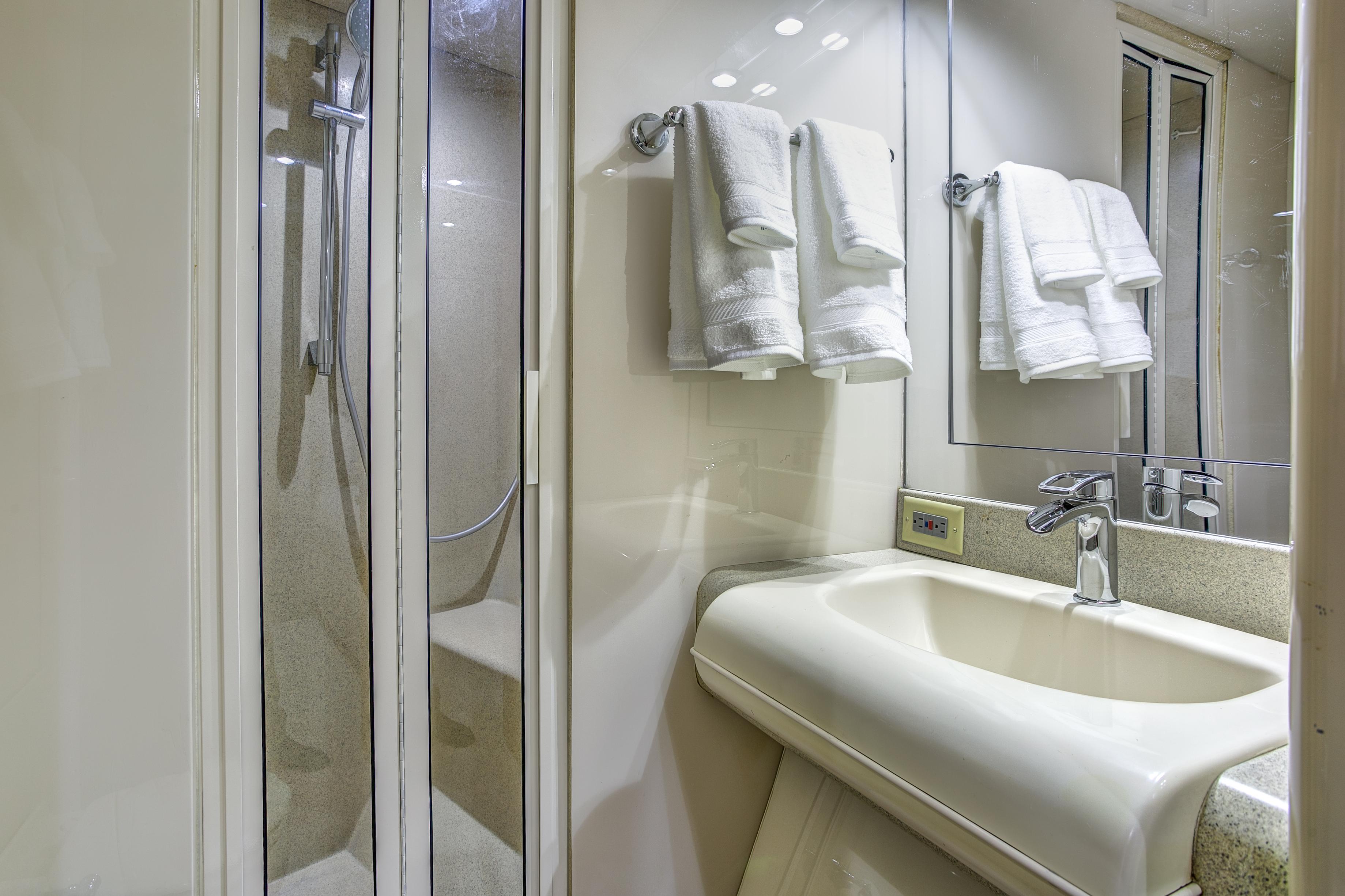 Lazzara-76 1994-MAUTICA FL-US-Luxurious bathroom in 1994 Lazzara 76 yacht with shower and elegant sink.-9595695 | Thumbnail