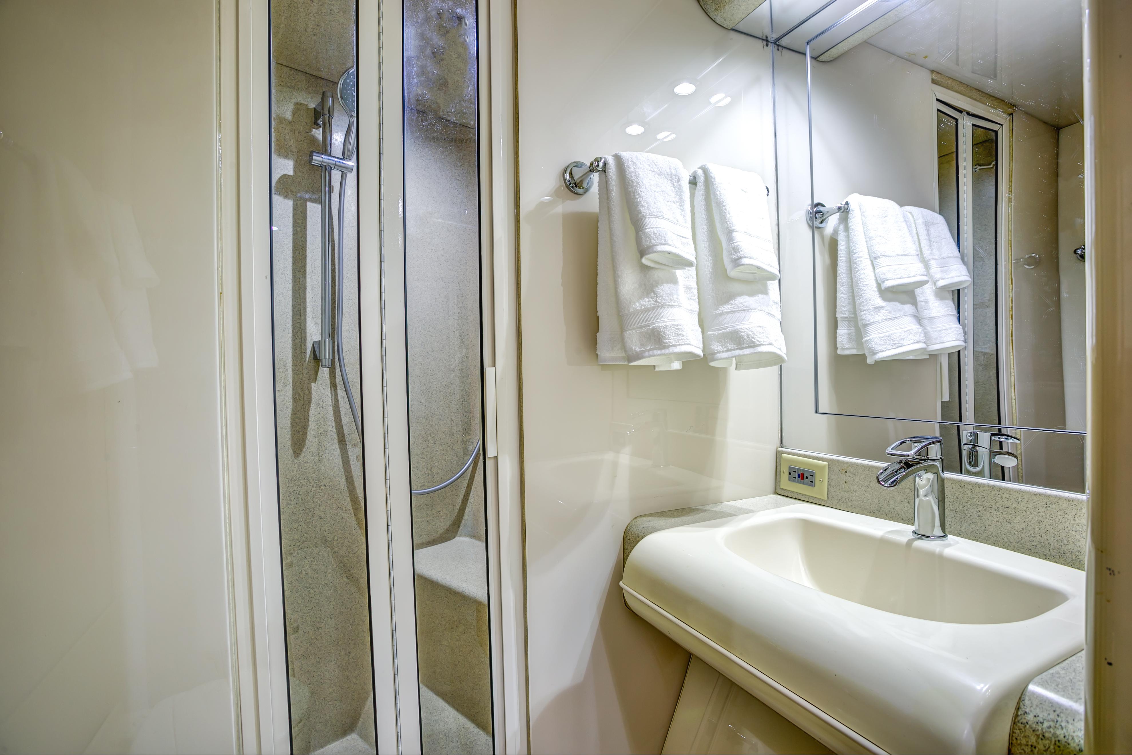 Lazzara-76 1994-MAUTICA FL-US-Luxurious bathroom in a 1994 Lazzara 76 yacht with shower and sink.-9595695 | Thumbnail