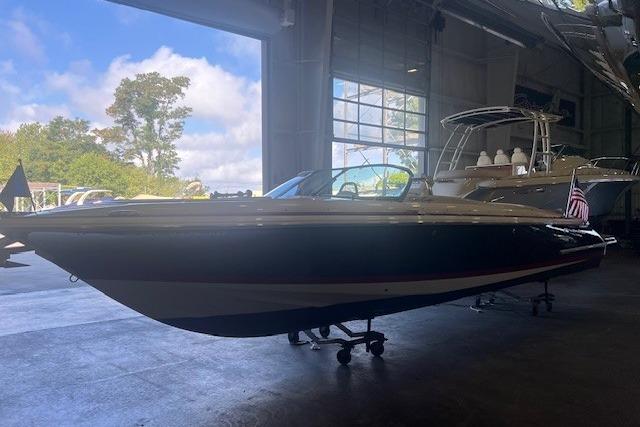 2024 Chris-Craft Launch 27 boat in a showroom, side view.