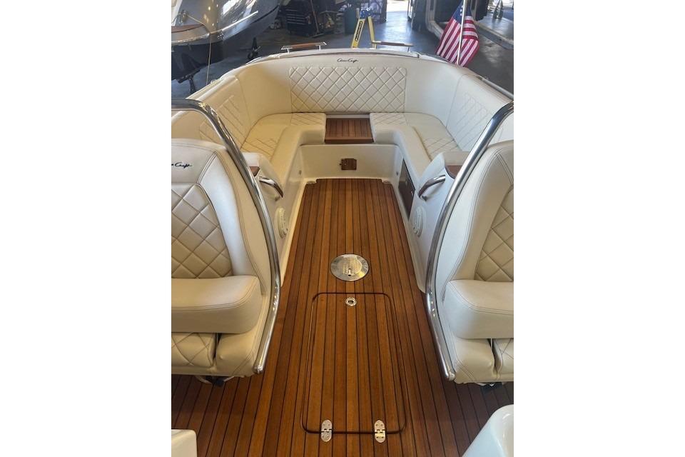 2024 Chris-Craft Launch 27 interior with luxurious seating and wooden flooring.