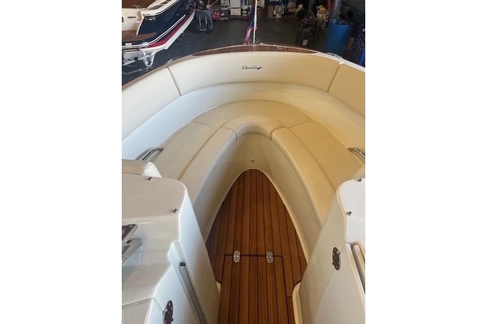 2024 Chris-Craft Launch 27 boat interior with elegant seating and wooden flooring.