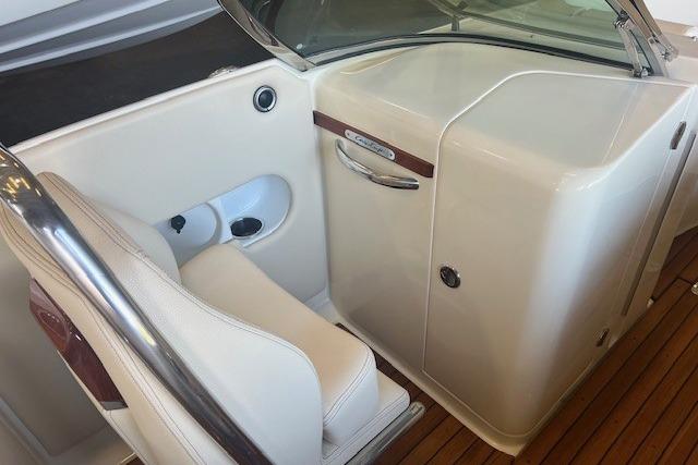 2024 Chris-Craft Launch 27 interior with white seating and wooden flooring.