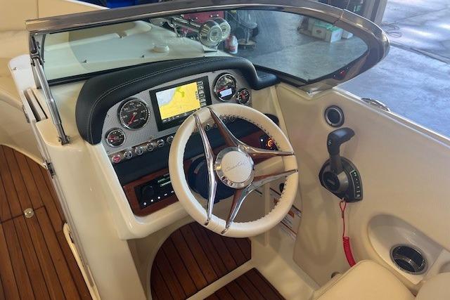 2024 Chris-Craft Launch 27 dashboard with steering wheel, navigation display, and control panel.
