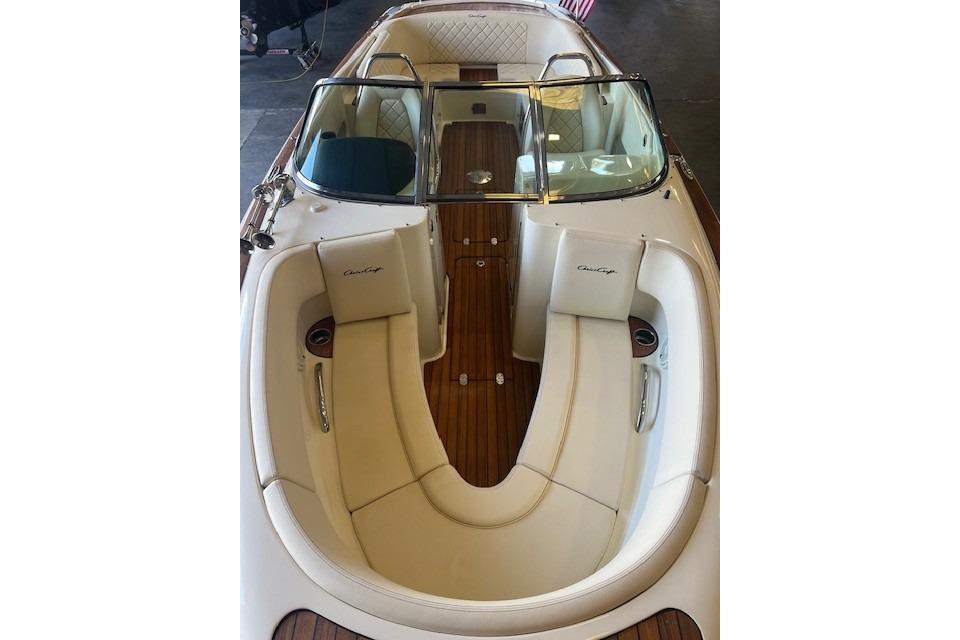 2024 Chris-Craft Launch 27 boat interior with elegant seating and wooden flooring.