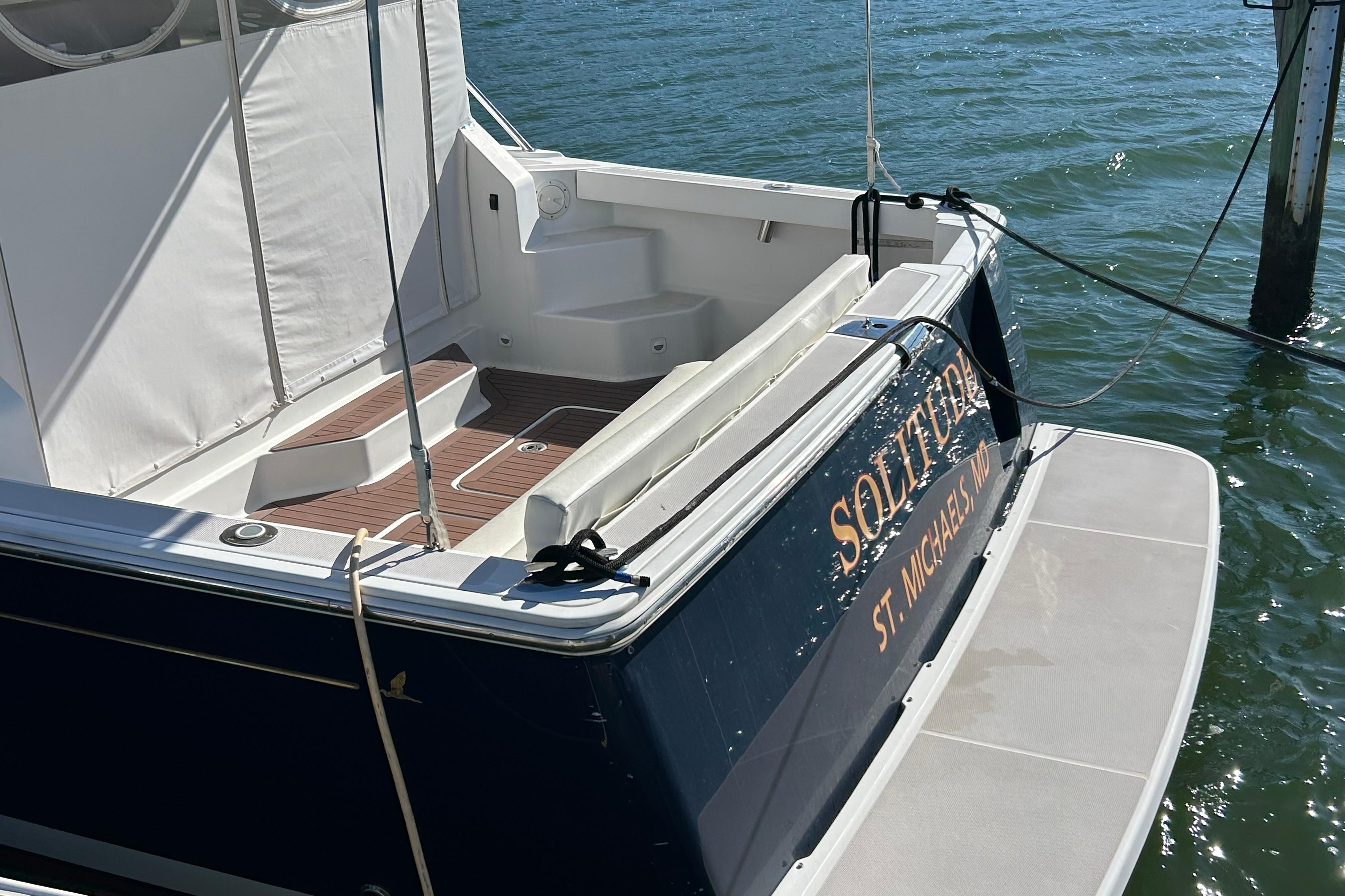 2008 Back Cove 33 boat docked, featuring a spacious deck and elegant design.