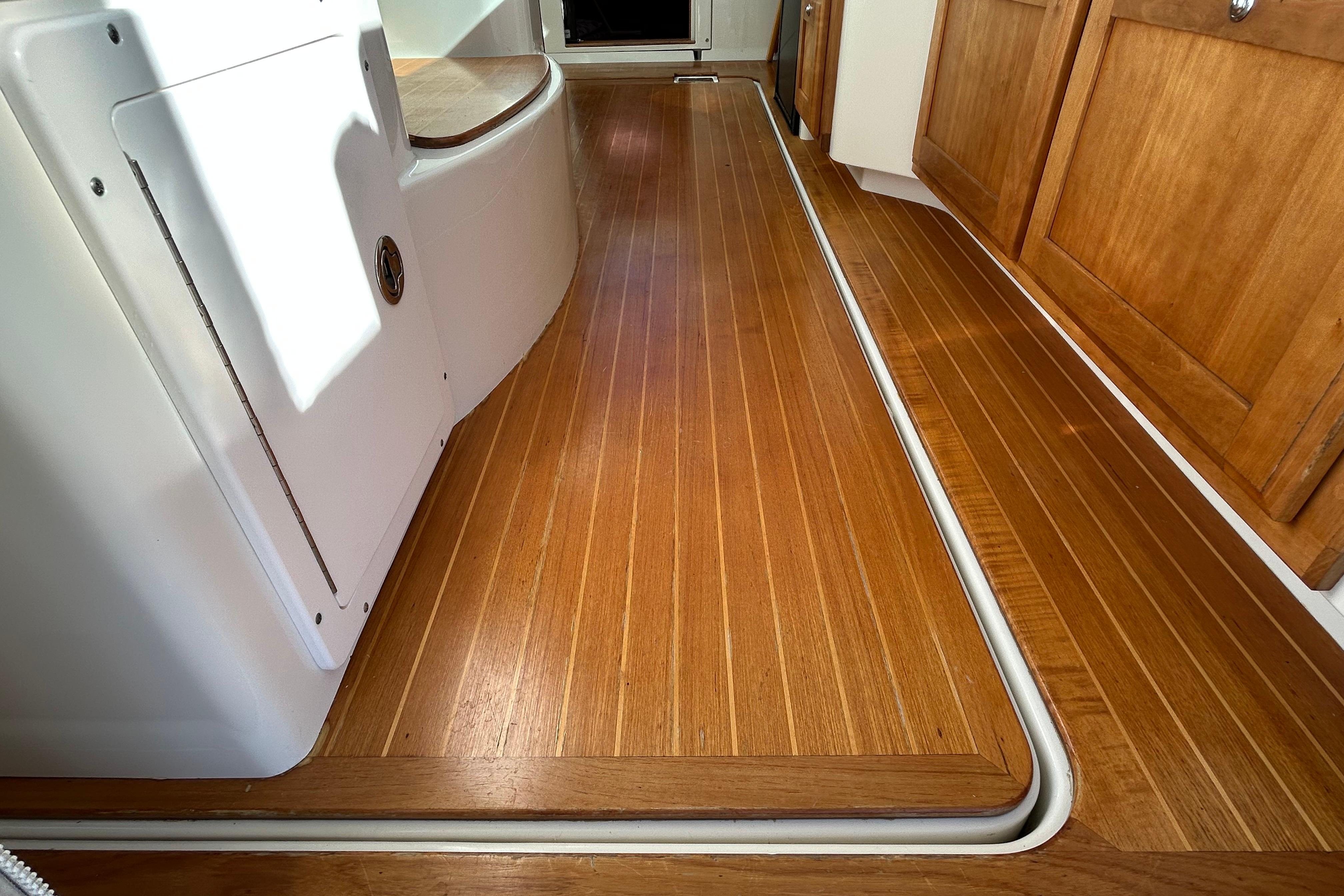 2008 Back Cove 33 interior with polished wooden flooring and cabinetry.